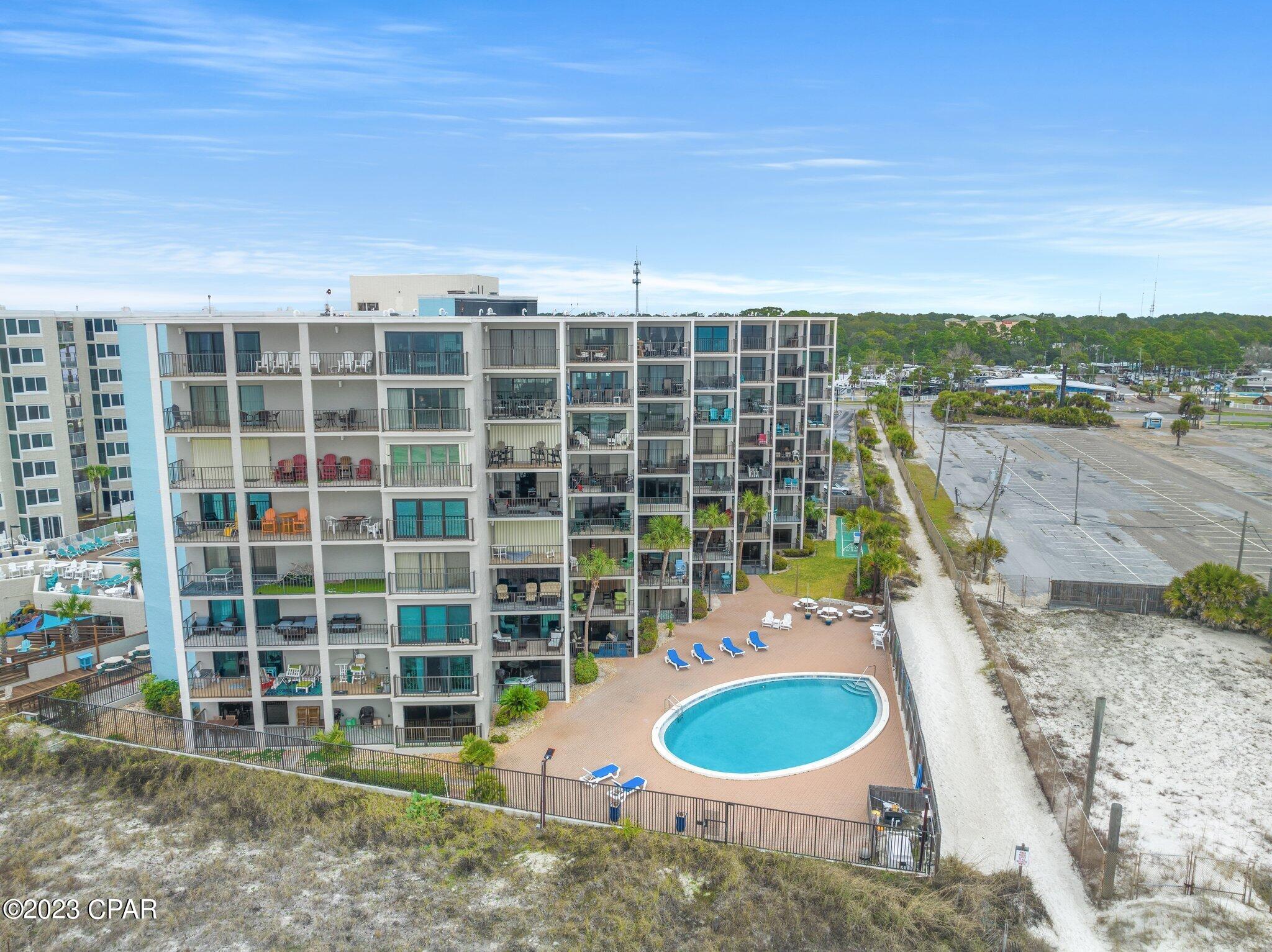 What a deal! This penthouse condo is one of the best priced gulf front condos in PCB, coming in at under $350,000! You will enjoy this small complex tucked away on the beach with only 61 units in the building. Moondrifter's location is perfect for walking to restaurants, attractions, and PCB'S night life. This top floor unit is a 1 bedroom, 2 bath coming in at 1048 sq. ft! Yes that's right, this condo is almost as big as some of the 2 bedrooms here in PCB.  Several units in this building have converted this floor plan into a 2 bedroom. There is also room for custom bunks to be added in the hallway. The seller has recently completed many upgrades like LVP flooring, quarts countertops, ect.  Now for the best part, the views! You will have the most beautiful sunrise views from your balcony. Vacation Rental season is right around the corner and this condo has the potential to produce over a 12%  gross ROI. Don't settle for a condo across the road from the beach, cash in on this deal today! Call me or your favorite agent for a private showing!