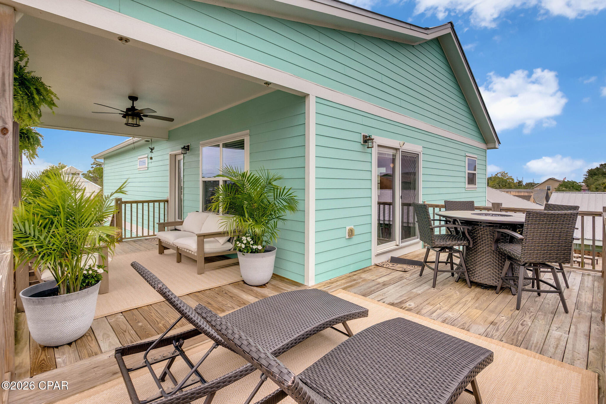 This newer construction offers flexible living options with a main home and an independent suite ideal for multi-generational living or income generation.

Welcome to the ultimate coastal setup and a massive financial opportunity--with absolutely NO HOA fees! Perfectly situated in a highly desirable pocket of Lower Grand Lagoon, this newer construction property puts you in the ultimate sweet spot: perfectly nestled between the open waters of the Grand Lagoon and the world-famous white sand beaches of the Gulf. Sitting safely in unincorporated Bay County also keeps your property taxes lower and your property rights greater than inside city limits, offering highly favorable, flexible rental rules and zoning. You have the ultimate freedom to park your toys and run your property your way.

You are centrally located to the area's best dining and entertainment, you are also just a short drive to the award-winning St. Andrews State Park--a pristine paradise where you can completely escape into nature and enjoy true solitude. On top of the unbeatable location, you are just 3 blocks from the premier boat ramp in the area, letting you get from your driveway to the water in minutes.
Offering a generous 2,002 square feet of modern interior living space, this property is masterfully designed as two separate, independent dwellings. This creates the perfect layout to live comfortably in the larger, spacious upper main home while generating immediate passive income from the independent lower suite. The lower dwelling is a proven cash-flow producer with a verified annual rental history and an upward-trending trajectory. Furniture is negotiable, making this the perfect turnkey setup to immediately jumpstart your rental stream or move right in with many brand-new items already in place.
The property also boasts a massive, fully finished 700-square-foot oversized double garage engineered to double as an incredible recreation area or game room. Outside, the heavy-duty, extra-wide 49' length x 25' width driveway is custom-built to effortlessly park a large boat trailer, center console, or full-sized RV with room to spare, complete with a professional dedicated 50-amp electric hookup to power your rig or marine craft.
Your private outdoor resort experience comes alive with over 800 square feet of expansive wrap-around decks and porches, offering a lovely peek-a-boo view of the shimmering Gulf waters and the ultimate setup for open-air dining, entertaining, or catching the sea breeze. These massive porch spaces overlook a fully privacy-fenced backyard. Designed with the plumbing and septic strategically placed in the front yard, the back is completely open and perfectly cleared for an inground swimming pool or a large lawn area for kids and pets to play. The yard already features a matching exterior storage building that is perfectly positioned to be easily converted into your own custom tiki bar, pool house, or surf shack. Complete with a built-in sprinkler system, outdoor shower, and a durable metal roof, this newer home is completely turnkey and ready for its next chapter.