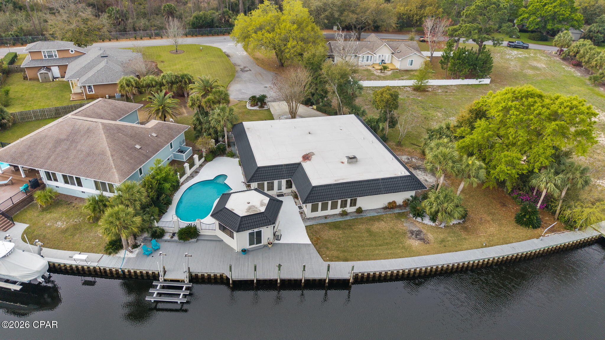 Enjoy waterfront living in Panama City Beach with 165 feet of canal frontage and Gulf access in approximately 7 minutes--perfect for boating and fishing enthusiasts. The property features a new boat lift and a roof installed approximately 5 years ago for added peace of mind. Relax or entertain outdoors with a private pool and pool house. Inside, the home offers additional flexibility with two bonus rooms ideal for a home office, guest space, or hobby area. Whether you're looking for a primary residence or the perfect coastal getaway, this property offers an incredible opportunity to enjoy the Panama City Beach lifestyle.