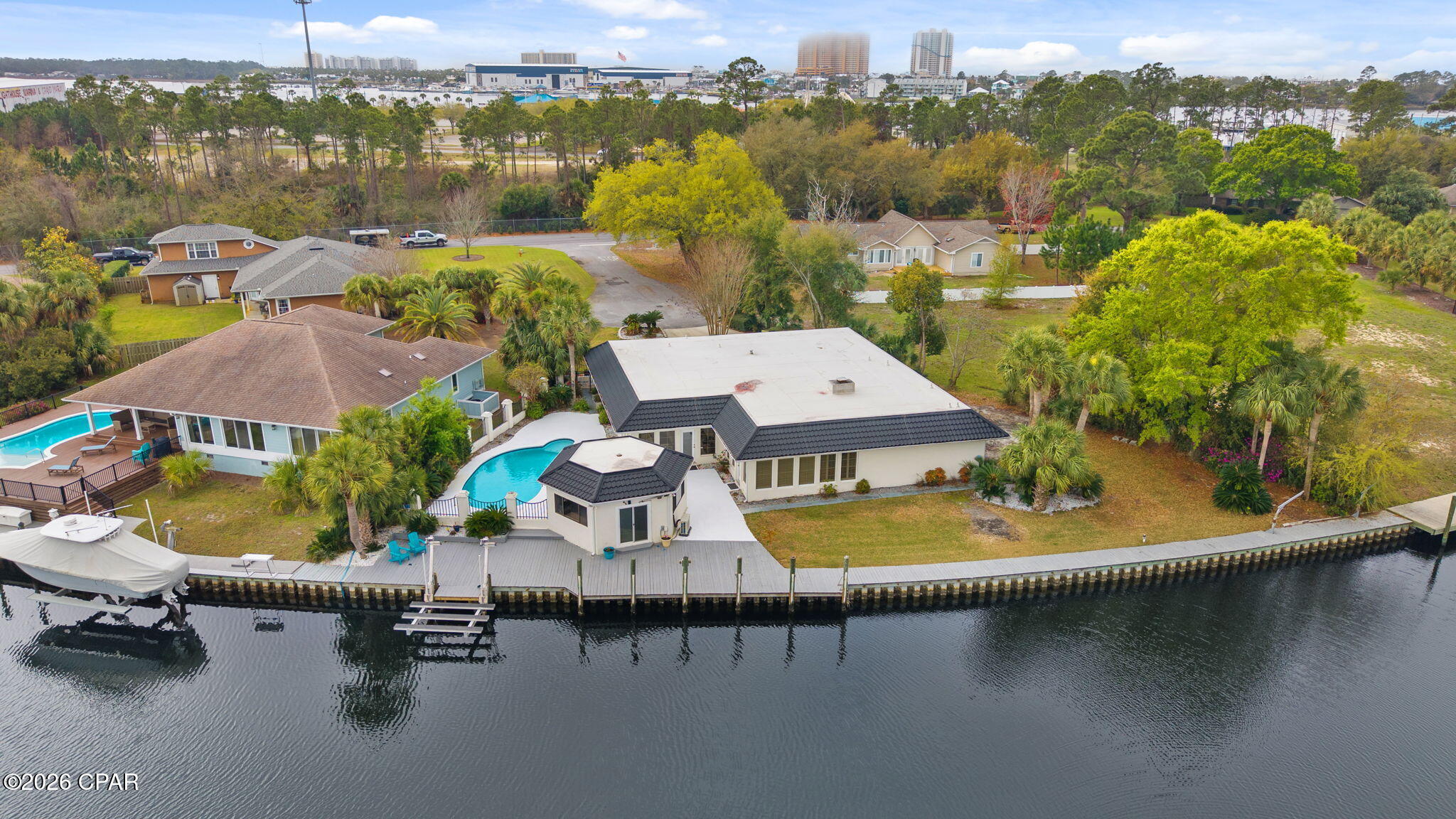 Enjoy waterfront living in Panama City Beach with 165 feet of canal frontage and Gulf access in approximately 7 minutes--perfect for boating and fishing enthusiasts. The property features a new boat lift and a roof installed approximately 5 years ago for added peace of mind. Relax or entertain outdoors with a private pool and pool house. Inside, the home offers additional flexibility with two bonus rooms ideal for a home office, guest space, or hobby area. Whether you're looking for a primary residence or the perfect coastal getaway, this property offers an incredible opportunity to enjoy the Panama City Beach lifestyle.
