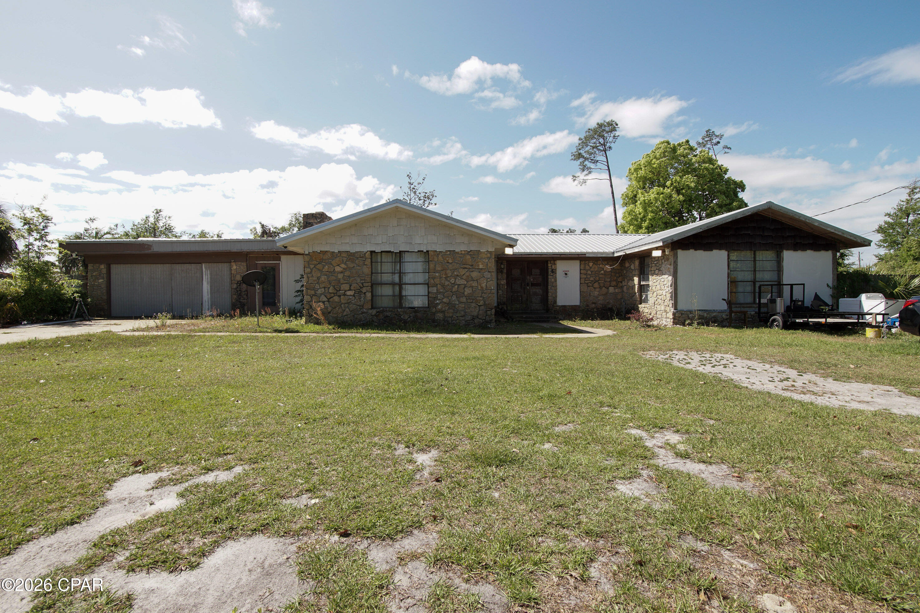 If you're searching for a property that offers the peaceful feel of country living while still being conveniently close to shopping, grocery stores, and schools, this is the perfect opportunity.

Situated on 5 acres in Panama City, this brick home features 3 bedrooms, 2 bathrooms, and just under 2,300 square feet of living space. The property is zoned R2, opening the door for multi-family development or investment potential.

With a tenant already in place, this home provides immediate rental income, making it an excellent option for investors or buyers looking for both space and opportunity.

The possibilities here are truly endless, whether you're looking to expand, develop, or simply enjoy a spacious property in a prime location.