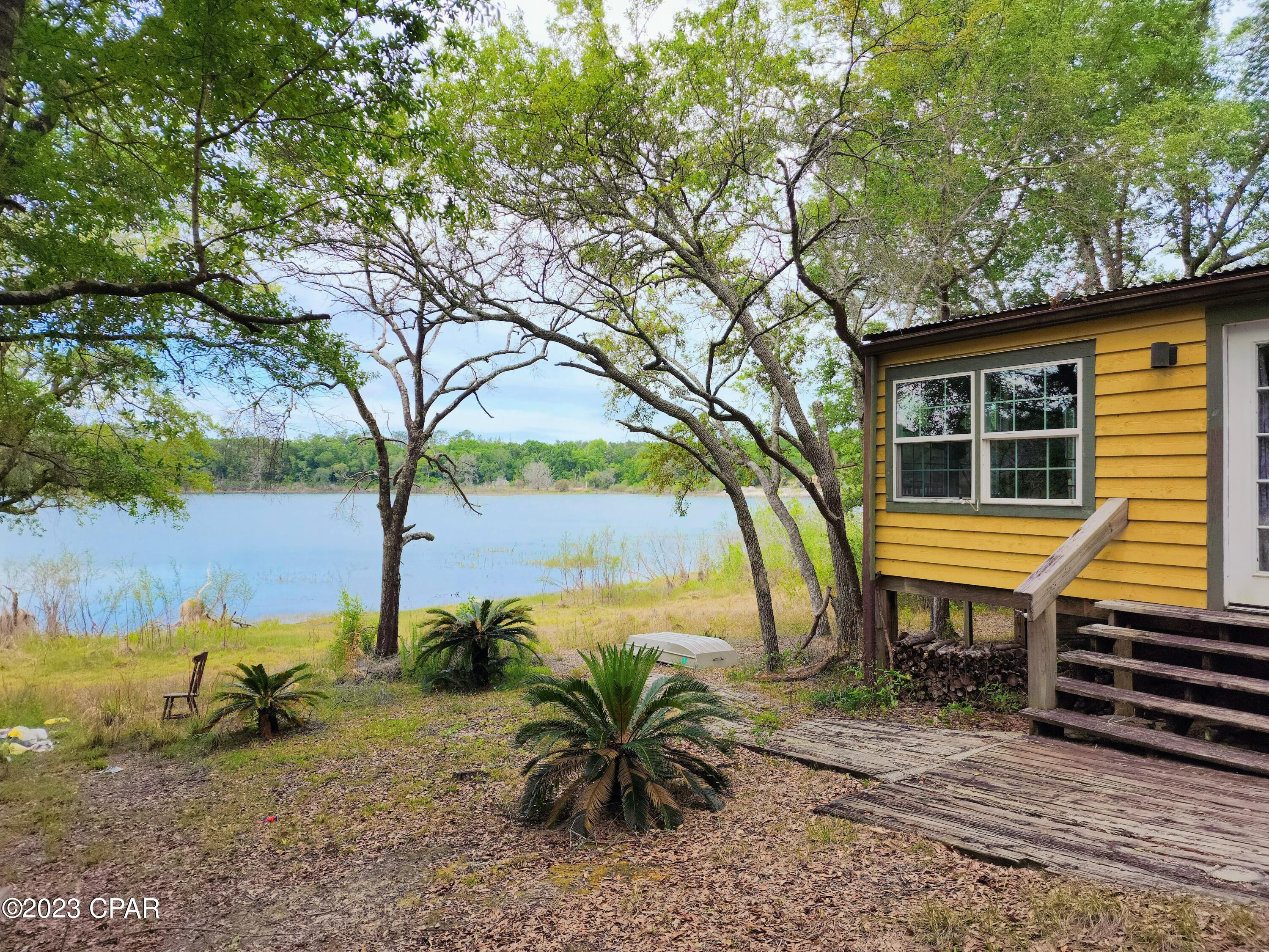 MULTIPLE OFFERS RECEIVED! Requesting all offers be submitted by 2pm Wed, May 3. 
Welcome to your own private oasis! This beautiful approximately 2 acre lot features an old hunting cabin situated on tranquil Stewart Lake. The cozy cabin has a rustic charm and offers a space to unwind and escape the hustle and bustle. With the lake spanning approximately 35 acres, bring your boat and enjoy plentiful fishing. There's also a public boat ramp nearby. In addition to the cabin, there was a bathhouse with shower and laundry, but it is in need of renovation. A pipe leaked during the winter freeze and the owner never knew about it. The property already has septic/well/power. There is no HOA and it would make an excellent homesite for those looking to build or place a mobile home! The picturesque surroundings offer a stunning lake view and provide the perfect backdrop for relaxation or outdoor activities. Don't miss out on this unique opportunity. Lakefront lots of this size don't come available often. It will probably require a cash buyer; no seller financing. There is a long, gated driveway. Please schedule a showing before walking the property. Lot dimensions are estimated. Buyer to verify all information to determine suitability.