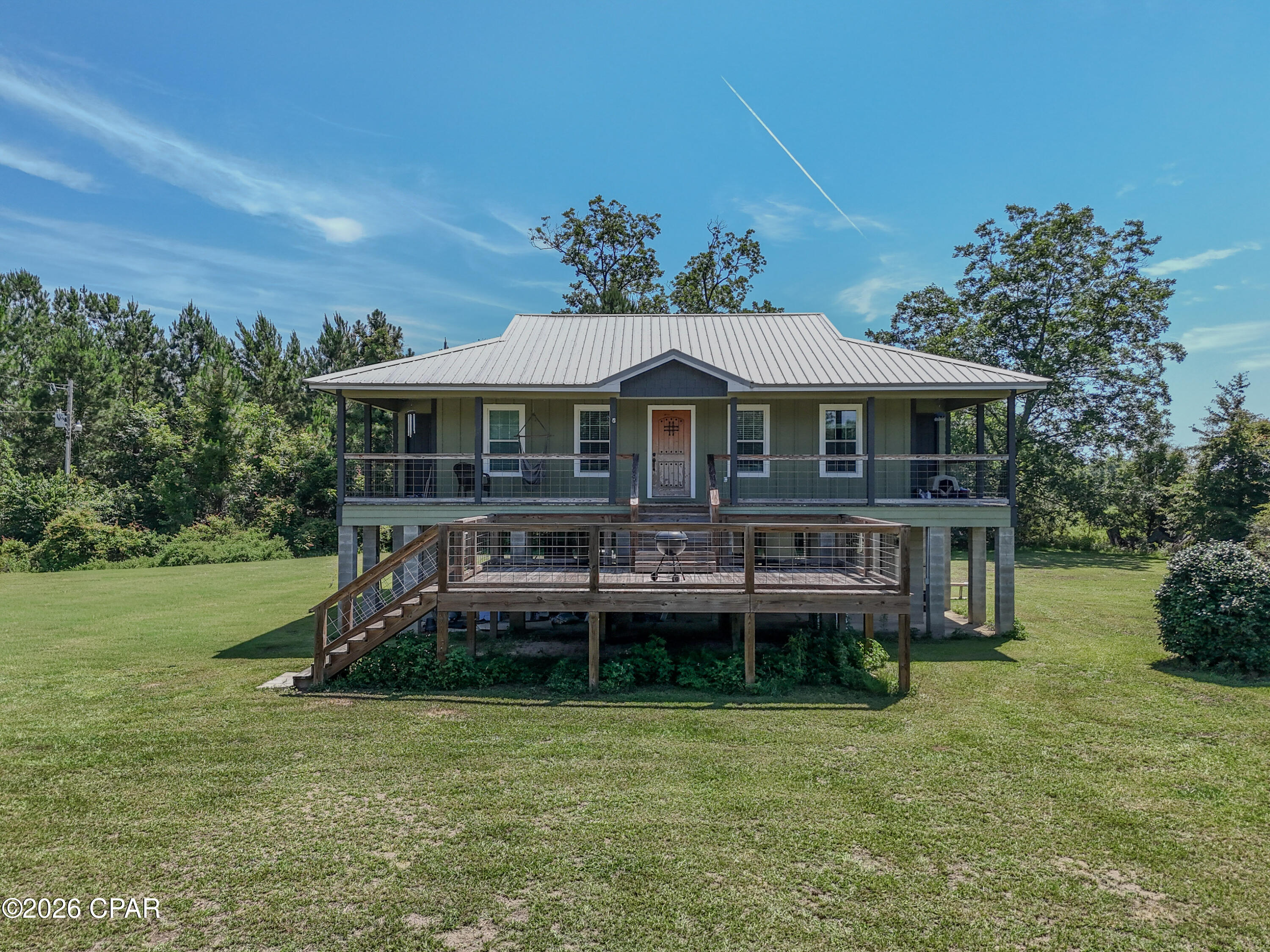 Coastal feel in the Country!

This 3 Bedroom 2 Bath pier and beam home resting on a gorgeous acre in southern Jackson County, offers a Coastal Flare combined with Southern Charm.

Outside, the pier and beam construction elevates the home to make way for the large open and covered deck system, and gives the owners the ability to utilize the ground floor for storage, or for later enclosure and addition. 

Inside, the home offers rustic tongue and groove walls, wood trim finishes, and that cozy county feel. The living kitchen, and dining areas flow openly and together, making family time a breeze. 

The master suite offers plenty of room for large furnishings and has a large walk-in closet for clothes and storage. The master bath features a good sized walk-in shower and oversized vanity with mirror. The accompanying guests rooms and bath are also very well sized, and offer plenty of room for a growing family.

Back outside, the property also boast a large pole barn for all of your toys and hobbies, and the property itself is primarily perimeter fenced. This one will not last very long, so schedule your showing on it today!