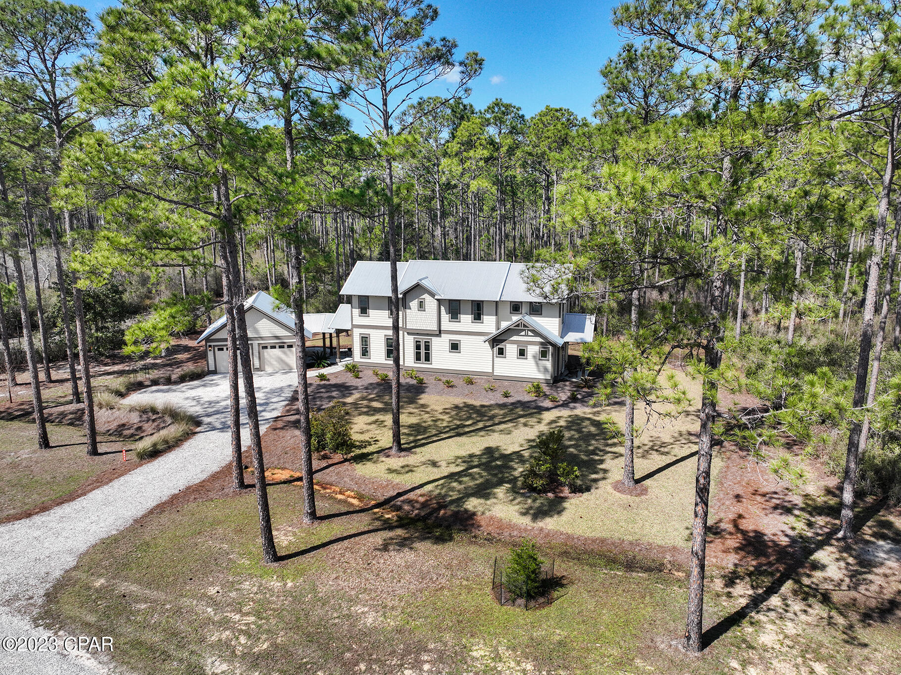 Upscale 2020 construction retreat in the gated waterfront reserve of RiverCamps on Crooked Creek. Enjoy the modern rustic design in this 3 BR/3.5 BA home with 2-car, insulated garage heated and cooled with a mini-split. The first floor has 10' ceilings and includes a guest suite with it's own full bath, a powder room, and large kitchen overlooking an open concept living/dining area. All windows have beautiful window coverings. There is a spacious screened in porch that is perfect for entertaining and an outdoor shower. The 2nd floor has 9' ceilings and includes a master suite, laundry room, loft space, a full bath and an additional bedroom large enough for a king size bed. Notable features include 8' interior and exterior doors, quartz countertops, oak shaker style cabinetry, designer light fixtures, Luxury vinyl plank flooring with carpet in bedrooms, Venetian marble countertops and subway tile in bathrooms. Exterior features include Navajo White Hardie plank lap siding with Timber Bark trim and a metal roof. RiverCamps is a coastal sanctuary designed to embrace the outdoors that is bordered by water on 3sides, the Intracoastal Waterway, Crooked Creek and the spectacular 18,000-acre West Bay. RiverCamps community offers outstanding amenities such as a RiverHouse with swimming pool, and pavilion, a fitness center, 7 miles of trails and boardwalks, and a boat ramp with access to the Gulf of Mexico. Owners enjoy onsite dry-boat storage and day-use boat slips all included in the low HOA fees. All of this located within the gated 1500 acre community of RiverCamps which will have less than 450 homes on 500 acres with the remaining 1000 acres committed to conservation. Call today to schedule your tour. Listing agent is the onsite, community specialist.