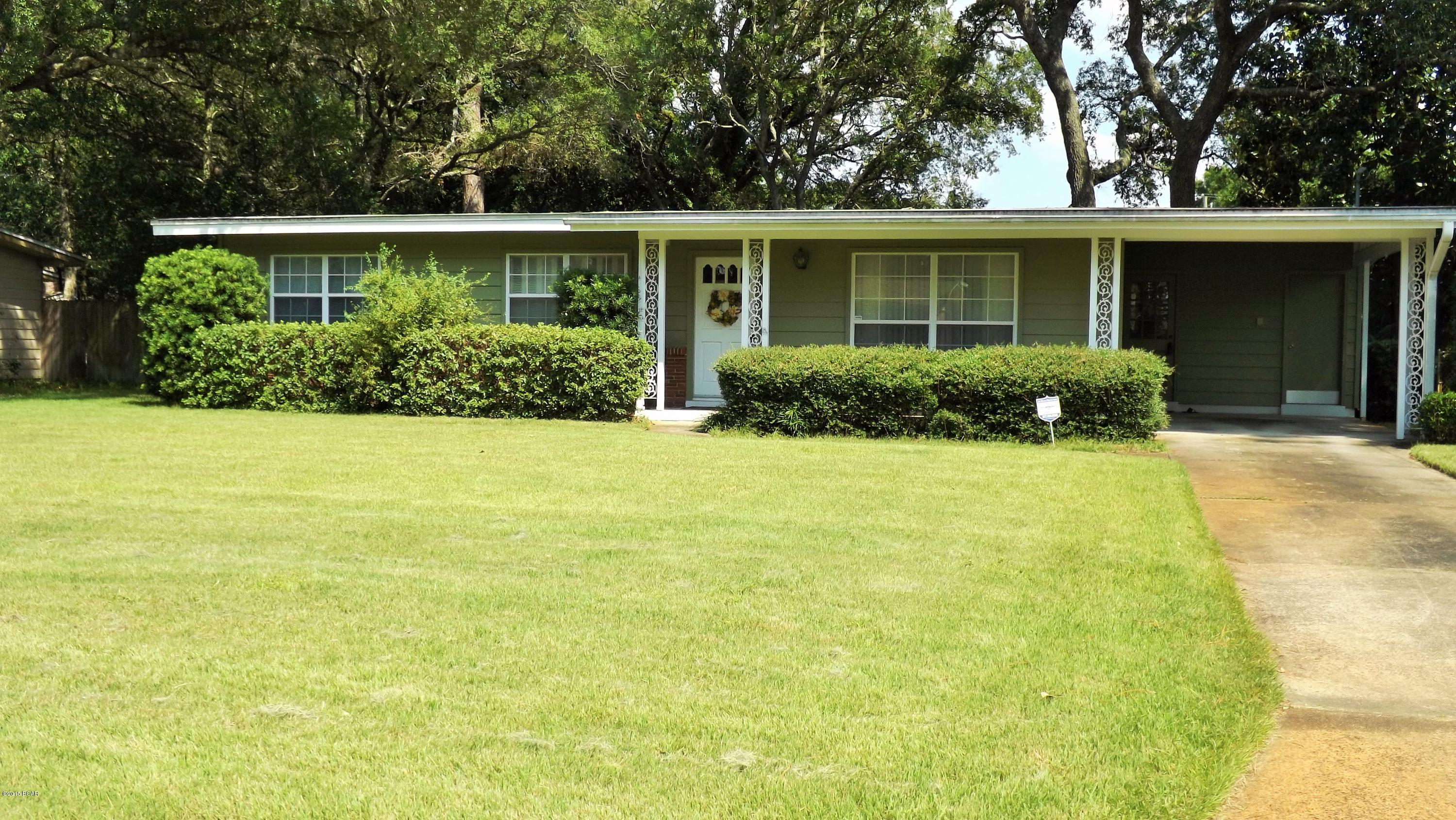 Gorgeous! Well cared for home with 3 spacious bedrooms and 2 bathrooms, in Woodlawn subdivision. Convenient to Panama City Beaches as well as dining, schools, and shopping. This home truly shows pride in ownership. New exterior paint on Redwood siding in 2012 and flooring updated in 2006. Sprinkler system on well and yard has been well cared for, evident in the curb appeal. Kitchen includes a breakfast bar and lots of cabinet and counter space. A formal living area adds an elegant touch to this spacious home. Open concept dining and den overlook a large fenced in back yard. Fenced in back yard features lots of space for pets and children. Don't miss this opportunity to buy!