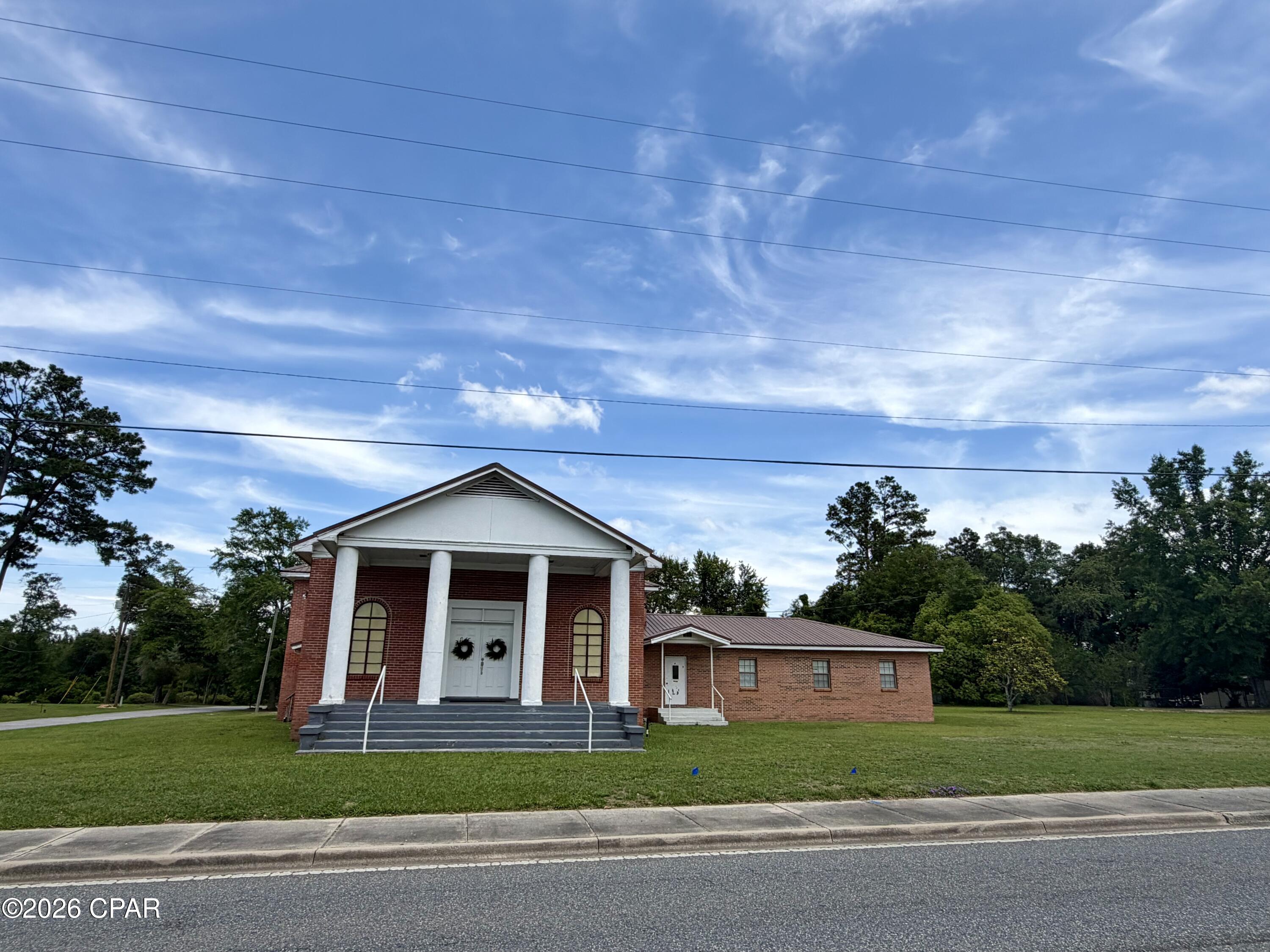 Approximately 184 feet of frontage on Highway 231 in Cottondale, Florida! Situated on a corner lot along a four-lane highway with a turn lane, this property offers outstanding visibility with a daily traffic count of approximately 9,100 vehicles. The brick church building, constructed in 1975, features approximately 5,525 square feet and includes a large sanctuary, spacious fellowship hall, kitchen with ample cabinetry, sink and residential stove, office and classroom downstairs, plus four additional classrooms upstairs. There are three single restrooms downstairs and one upstairs restroom with a tub/shower combination. Please note: some cloth wiring is present (see photos).

Additional improvements include two storage buildings and an older single-wide mobile home on the property. With excellent highway exposure and versatile space, this property offers endless potential for a church, daycare, community center, office conversion or other commercial uses.