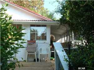 FURNISHED! Lakefront beach cottage across from the beautiful Gulf of Mexico. This cozy home is located on a secluded lot with extensive landscaping features such as fruit trees and trellis gardens with a European feel. Pets Negotiable.**SHOWN BY APPT ONLY**