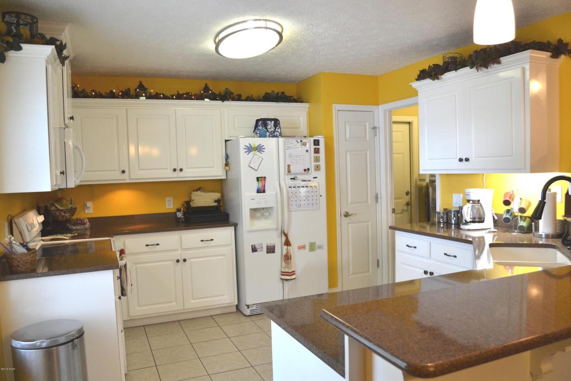 Gorgeous, well maintained home located near two of the most popular schools in the school district, Tommy Smith and Merritt Brown.  This 3 bedroom, 2 bath home looks and feels like brand new!  The interior has an open concept with the kitchen opening up to the dining room and the extra large living room that measures 14x26.  Crisp white kitchen cabinets and granite counter tops give the kitchen a gourmet feel and the breakfast bar that separates the kitchen from the dining room provides even more space when cooking, entertaining or relaxing.  The living room was extended 10 feet longer than the original plans and makes for plenty of room for a sitting area or a small office area.  A fireplace is the focal point of the living room.  All three bedrooms are very large, especially the master