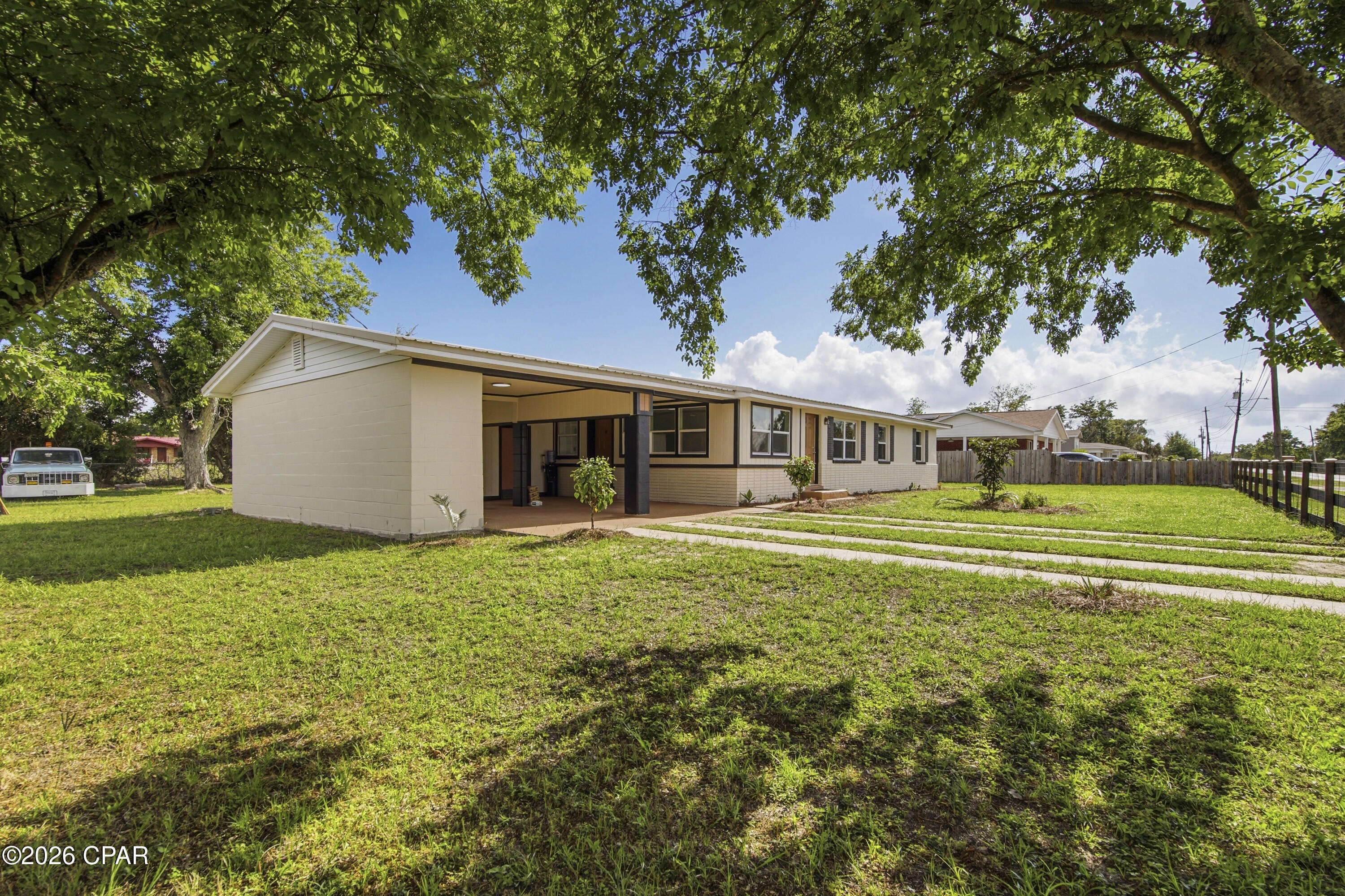 Opportunities like this are exceptionally rare -- a beautifully remodeled property with MIXED USE zoning that allows you to legally LIVE and WORK in the same space. Whether you're an entrepreneur, small business owner, creative professional, investor, or simply someone who wants flexibility for the future, this property delivers a lifestyle and business opportunity that's hard to duplicate.
Perfectly positioned near Tyndall Air Force Base and just off busy Tyndall Parkway, the location offers both convenience and visibility with strong traffic counts for potential business exposure. Unlike standard commercial zoning, the Mixed-Use designation in this area allows residential occupancy -- giving you the freedom to operate a business without sacrificing the comfort of home.
Inside, the remodel is nothing short of brilliant. Every inch of the space has been thoughtfully reimagined for maximum functionality, flow, and style. The main area of this home features a living room, dining area, remodeled kitchen with quartz countertops and new stainless appliance package and 2 bedrooms and 2 full baths, including a stunning newly created primary suite complete with an ensuite bath and walk-in closet.
On the opposite side of the home, on the other side of the living room, there is a separate flex space with an oversized closet and an exterior door that walks out into the carport, which creates endless possibilities. Use it as a private third bedroom, client office, salon studio, creative workspace, consultation room, boutique, or home-based business -- all without clients or customers ever needing to enter your main living space. It's the ideal setup for maintaining both professionalism and privacy.
Outside, the oversized corner lot adds even more value and versatility. The fully fenced yard with front and side gates provides security and functionality, while the drive-through carport and generous parking areas make access easy for personal vehicles, trailers, work trucks, or business clients. There's plenty of room here to truly make the property work for your lifestyle.
Additional features include: huge corner lot with excellent accessibility; fully fenced with solar light post caps and multiple gated access points; large slab for the addition of a future shed; drive-through carport; working irrigation pump; flexible floor plan with residential and business potential; excellent visibility and convenience near shopping, dining, and Tyndall AFB; rare zoning flexibility in a rapidly growing area!
This is more than just a remodeled home -- it's a smart lifestyle investment that gives you options, flexibility, visibility, and freedom all in one property.