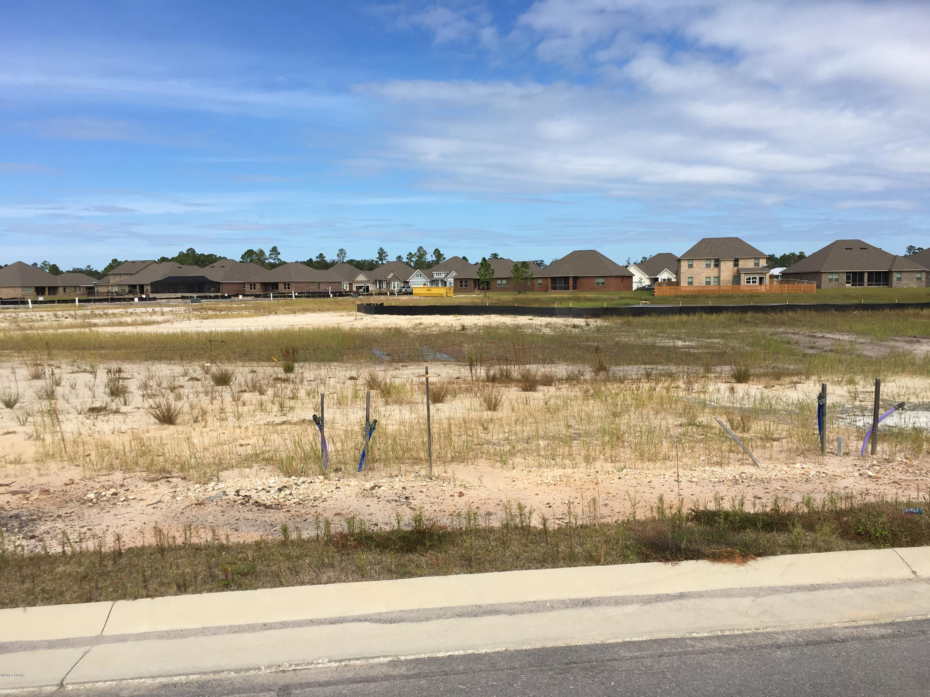 Build your home in Lynn Haven on this lot that backs up to Saw Grass Pond and walk down to the HOA maintained park areas on the bayou. Neighborhood has pool, firepit, sidewalks, street lights, wide streets for on street parking, 2 dedicated parks, conservation land, and ponds throughout. The development contains Deerpoint elementary on the north and North Bay Haven Charter Academy within walking distance on the south. Lot has potable water, reuse for low cost lawn and landscape irrigation, power, sewer, and natural gas.