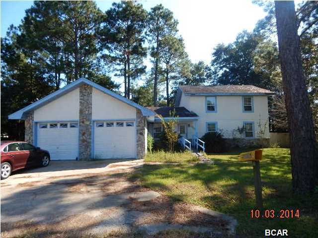 Large 4 bedroom house with loads of potential in desirable Lynn Haven. Spacious kitchen is open to large family room w/fireplace. There are 2 half baths downstairs, along with the master bedroom & attached full bath, an additional bedroom, and formal living area. Upstairs, you will find two huge bedrooms and one full bath. Property being sold As Is. All measurements approximate, please verify if important.