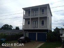 Great beach house located in the Thomas Drive S. Lagoon area, and just a few blocks from the beach, restaurants, fishing, and shopping.  This home features hard wood floors, crown molding, fenced yard with private pool and tiki ''bar'' area.  The 4 bedroom is a separate room with 1/2 bath off of the pool deck with full kitchen.