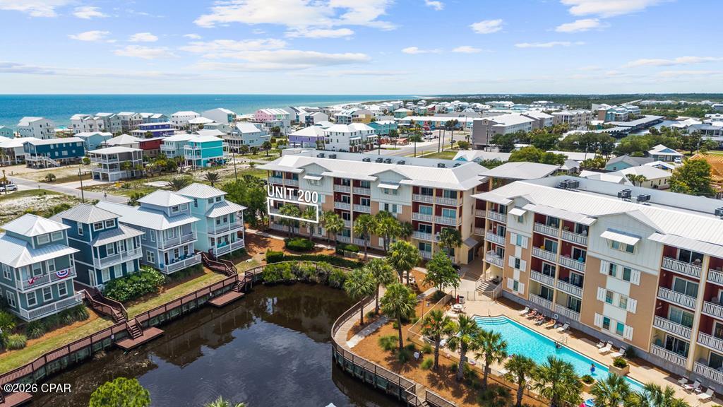 Welcome to Waterside Village #200, a fully furnished 3BR/3BA canal-front condo in the heart of Mexico Beach, offering 1,529 square feet of beach living. As the end unit closest to the beach, this second-floor corner unit offers great Gulf and canal views, visible right from the private balcony. The open-concept layout features a breakfast bar, walk-in closets, and lots of natural light, and was renovated Post-Michael with quality finishes throughout. The unit features two master suites, each with its own bathroom, with one offering a king bed and the other offering a unique setup with built-in bunk beds and a queen bed, perfect for families or larger groups, sleeping up to eight total. Waterside Village offers resort-style amenities, including a large waterfall pool, hot tub, boat hook-ups, elevators, and pet-friendly living, and the beach is just a measly 750 feet away. Short-term rentals are allowed, and this unit comes with a well-established rental history, featuring over 50 five-star reviews on VRBO, ranked in the top 10% of guest reviews in the area. Sold fully furnished and ready to go, just show up, unpack, and start enjoying everything Mexico Beach has to offer. Call today!