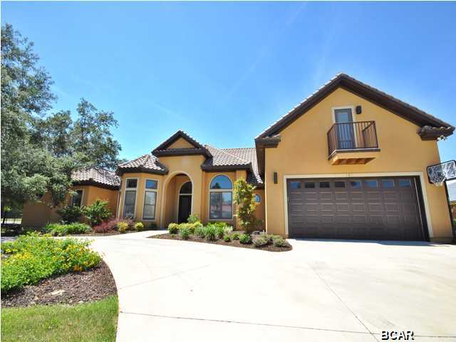 This is a true custom built home, when you walk into this beautiful abode you will notice style and elegance like no other home in Bay County! Every little aspect of this home had the thought of sheer class and style. As you enter the front door you will notice a large foyer area with a Baby Grand Piano to the right, which could double as a formal dining area, straight ahead is a spacious sitting area, high ceilings with two stage crown molding and first class tile flooring with the look of light wood. This is a split bedroom floor plan with the Master suite featuring a large bedroom with French Doors leading to the outside patio, Master Bathroom features separate shower, Whirlpool Tub, double vanity and very large closets. Just off the Master Suite their is an exercise room which could easily be an Office or Den. The Kitchen is perfect for entertaining as it overlooks the very spacious and open family room and the pool and patio area outside. Plenty of cabinet space all custom made and includes Quartz counter tops. All very high end Stainless Steele appliances with Gas Range, perfect for the chef of the family. The first floor also features a play room and two other bedrooms. Upstairs you will notice another bedroom with full Bathroom, complete with Microwave, sink, fridge and bar area, this could be a great Mother in Law area. Also upstairs there is a recreation room that currently has a pool table and sitting area. Outside is absolutely fabulous, with in ground pool overlooking the Golf Course, complete with out of ground hot tub and your own Zip LIne on the side of the house! This house has it all and is a must see, you will be amazed as to all this house has to offer. Call today to make an appointment for showing!