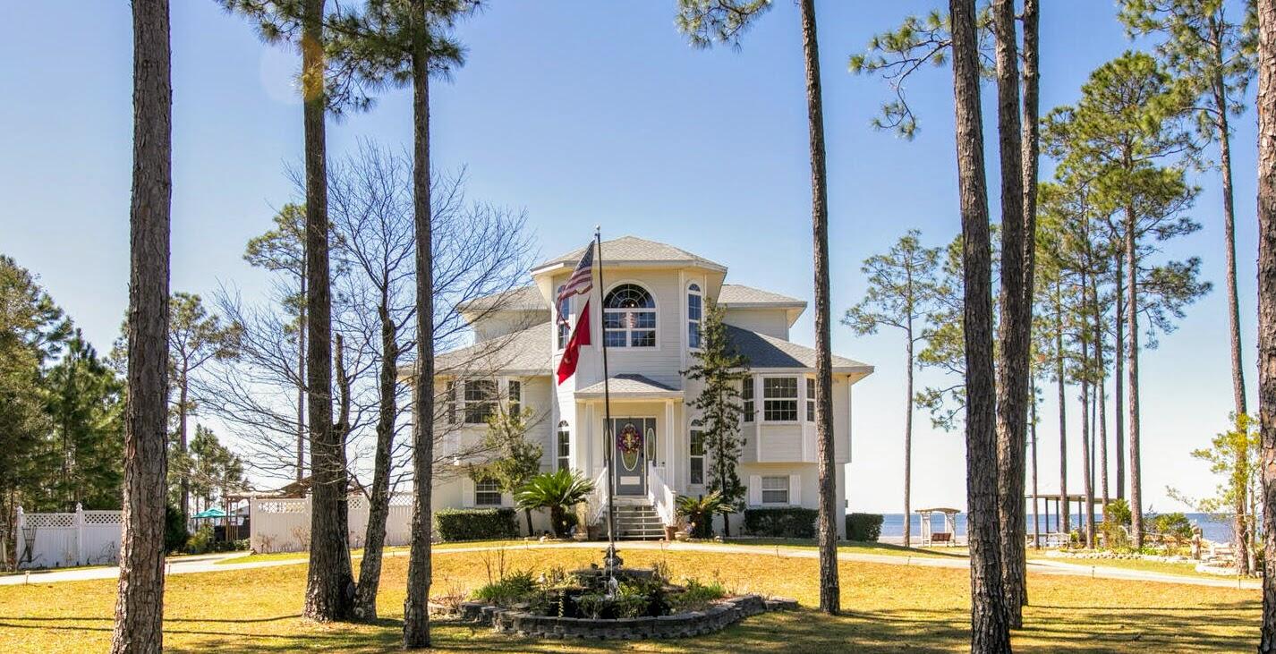 Wake up to an amazing sunrise in this beautifully maintained Choctawhatchee Bay front beauty.  Located in Bay Harbour, Freeport, Florida's premier bay front neighborhood, this custom home is centered on a double lot and features 160+ feet of bay front. A beautifully landscaped property & circular drive welcomes you into a spacious home & spectacular bay views. Bamboo floors, soaring ceilings, cozy fireplace, updated appliances & large porches are just a few of the comforts to be enjoyed. A bonus room as well as 3 car garage and bayside porch lead to your walkway to the bay. Great for entertaining, this home has it all. The master suite with private porch and bay view offers privacy and tranquility.  Enjoy the sunset from your boathouse & fish from your pier.  Live your best bay life