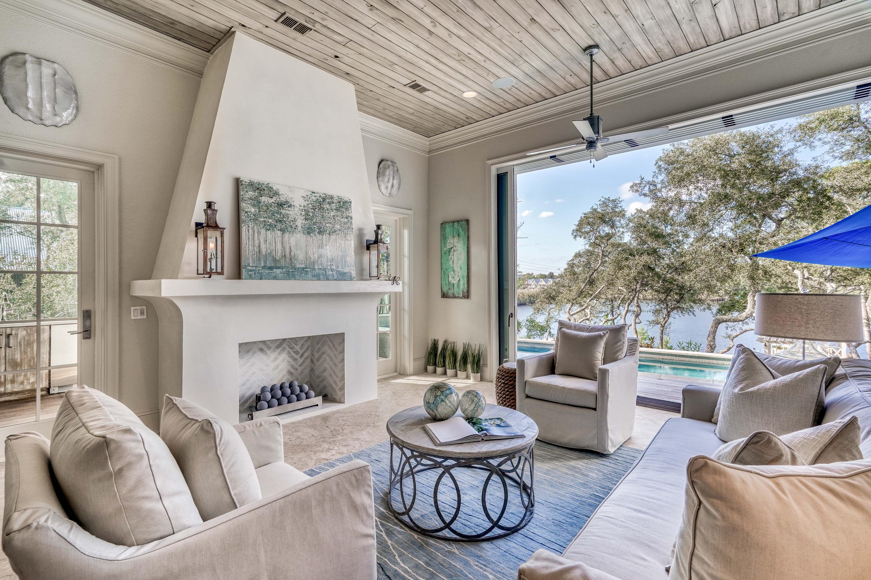 Discover an unmatched sense of privacy, impeccable luxury and incredible water views at this 6BR/6.5BA estate with private saltwater pool and dock draped along the shores of Camp Creek Lake, one of South Walton's rare coastal dune lakes. With over 6,200 square feet, elevator access to all three stories and expansive views of both the lake and the Gulf of Mexico, this home will stun from the moment you enter the front door. Immaculately maintained by the homeowner, an area luxury home builder, as a primary residence, the attention to detail is evident throughout with notable features including custom millwork, travertine and hardwood floors, IPE Brazilian hardwood decking, coffered ceilings, granite countertops, custom built-ins and much more. See ''More''. The first story includes two master suites, both with lake views, two guest bedrooms with ensuite bathrooms and an office currently used as a playroom. A fully equipped, gourmet kitchen offers everything needed or desired with commercial grade appliances, a breakfast bar, center island and ample storage. The spacious dining and living areas feature an ideal flow for entertaining with a secondary living space accessed through fully retractable accordion doors complete with fireplace that also fully opens to the outdoors with a second set of retractable doors. A screened outdoor kitchen offers direct access to the lake front spa and saltwater pool and includes a Wolf built-in gas grill with side burner, Green Egg, Sub Zero refrigerator, Wolf oven, sink and retractable screen next to pool. Gaze onto the calm waters of Camp Creek Lake and the wooded backyard from the pool loungers or stroll down a brick paver path to the dock for an afternoon paddle around the lake. The newly built dock, arbor and ramp allows access for a small boat and includes a picturesque, partially shaded seating area. On the second story, find a grand master suite with a steam shower, soaking tub, dual vanities and custom closet along with another large master suite, both with lake views. Ascend to the third level for breathtaking, panoramic lake and Gulf views from two separate seating areas, one covered and one open. An outdoor wet bar with wine refrigerator makes this the perfect space to savor amazing South Walton sunsets. A soothing beach house style with a neutral coastal color palette defines the interior spaces and the property can be purchased partially furnished. Additional highlights include a large downstairs laundry room, laundry hook-ups from both second-floor bedrooms and an oversized two-car garage. Camp Creek Drive is conveniently located along Scenic Highway 30A near Seagrove Beach, WaterSound Beach and Alys Beach. Shopping, activities and dining are minutes away, yet the location provides a serene retreat tucked away from the crowds.