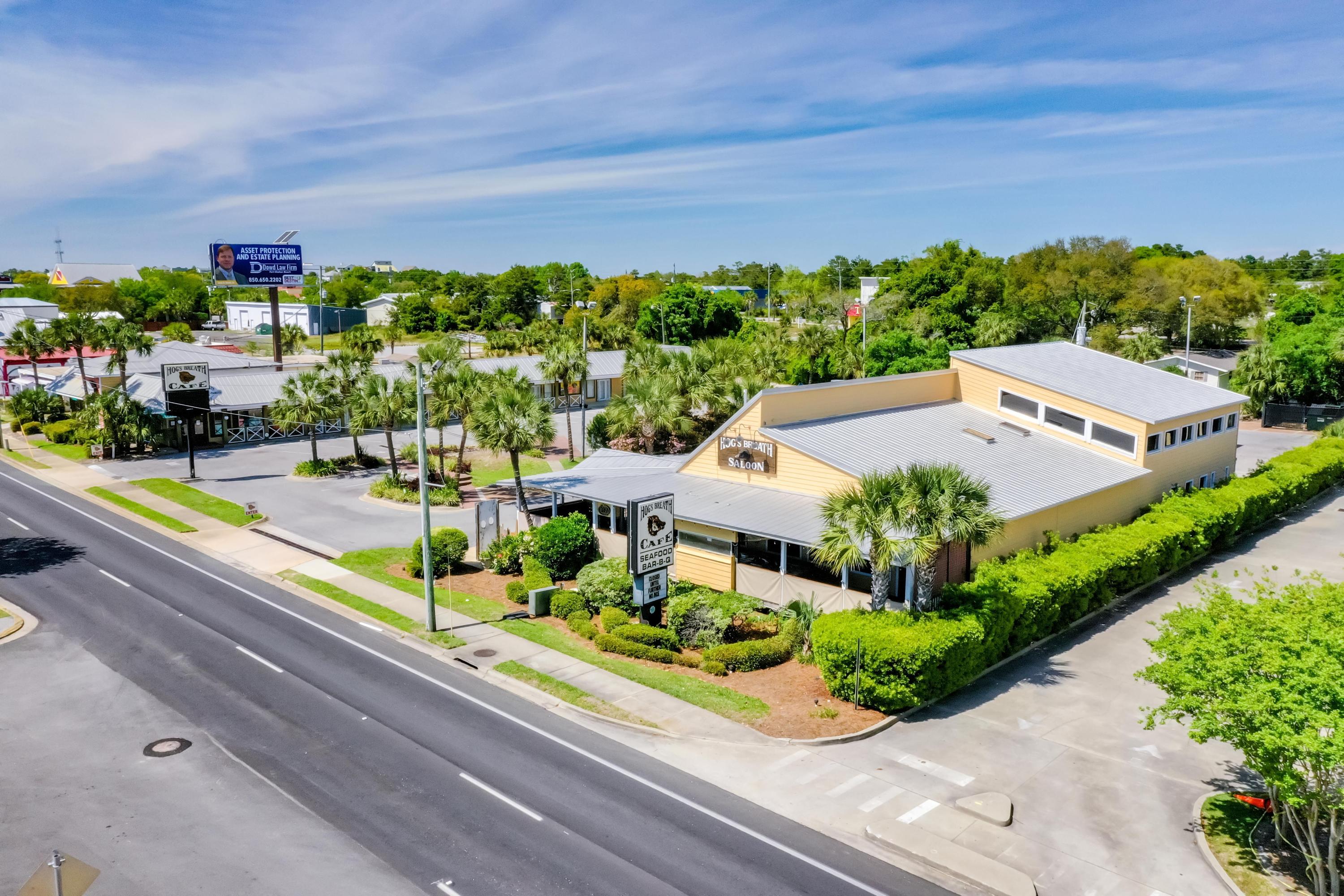 Superb 1.9-acre assemblage in the Harbor District of Destin, Florida, which coveted site has been operated as the Hog's Breath Cafe & Saloon for decades. The (5) contiguous parcels of Okaloosa County are located in the City of Destin and extend from Highway 98 (aka Harbor Boulevard) to Mountain Drive, and includes a fully-fixtured restaurant, special events space, multiple interior and exterior bars, expansive covered decks, operating smokehouse and separate icehouse, retail store, former in-line motel, office cottage, and an abundance of parking. This rare, second generation restaurant opportunity offers a turnkey, revenue-producing site for your food, beverage, and retail concept. The improvements have been well-maintained throughout the years. A 4COP beverage license.... also available, allowing for package liquors, which would be an ideal retailing use along with the sale of memorabilia from the secondary, freestanding retail building fronting Highway 98.  The visibility factor of the site and its accessibility onto its 250' of road frontage is exceptional.  The site is directly across from Harbor Docks.  Please inquire for further details, as well as for images depicting the furniture, fixtures, and equipment.  The approximate heated/cooled square footage allocations are as follows: Freestanding Restaurant & Bar: 6,088 SF / Freestanding Retail Building: 1,258 SF / Former In-Line Motel: 3,396 SF / Office Cottage: 1,000 SF.  Approximately 104 parking spaces and approximately 260 seating capacity