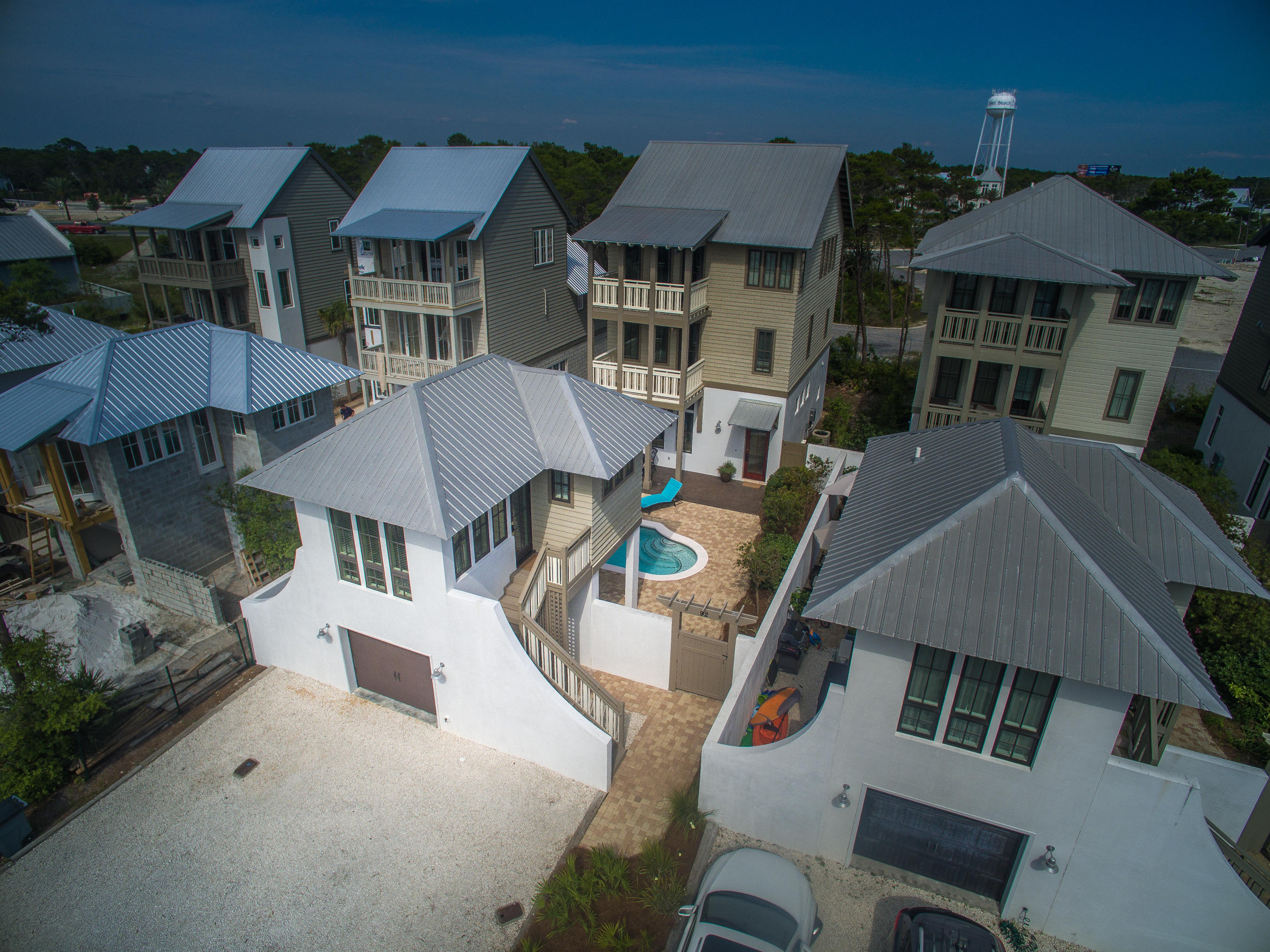 No detail has been overlooked in this 5 bedroom, 5.5 bath Rosemary Beach House eqipped with an elevator and that is just seconds from the community of Rosemary Beach, FL. Lucrative rental property, vacation home or full-time residency located on the north side of Scenic Highway 30A. You can wake up and walk to the Rosemary Beach town center for dining, shopping, farmer's markets, spas, or just having fun with your family and friends. This beach home welcomes you with an expansive courtyard with salt water pool, private patio and sun deck separating the main house from its carriage home. Enter to the open concept spacious living and dining areas of this home with wood floors, fireplace, a beautiful reclaimed wood dining table and large windows letting in scores of natural lighting. The kitchen, fit for a chef, is equipped with granite countertops, Bosch stainless steel appliances, gas range with vented hood, wine fridge, breakfast bar, and three large storage closets; perfect for entertaining. The convenient half bath finished in shiplap is located on the main floor and perfect for guests. On the second level of this home you will find a bunk room with four floating bunks, a walk-in closet, full bath with stand up shower, a separate spacious living area and a King guest room. This guest room is equipped with a full bath, expansive walk-in closet and a private covered balcony. On the third floor of this beach house, you will find a King master with a cathedral ceiling, expansive walk-in closet, master bath with garden tub, stand up shower, and his and her vanities. On this floor you will find a second King master bedroom with a large closet, master bath with garden tub, stand up shower, double vanities, and a private covered balcony. To schedule a showing of this Rosemary Beach House, call the Beach Group today!
