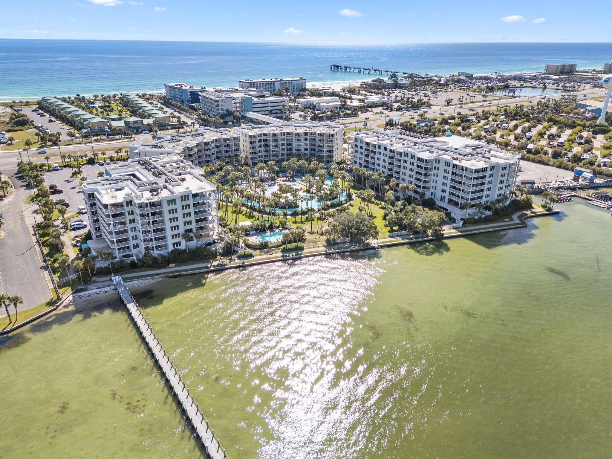 Nestled on the scenic waters of Okaloosa Island just east of Destin, this furnished 1-bedroom, 2-bath haven offers 971 sq ft of coastal ease and refined comfort. The bright, open living space flows to a private lanai where lagoon-pool and bay views frame each morning coffee and evening breeze. Inside, you'll find upscale finishes and tile flooring in key areas, washer/dryer, and a sleek kitchen ready for casual cooks or entertaining. Located on the bayside of the resort-style complex, you'll enjoy easy beach walkovers, lazy river and spa amenities, and a private garage. With both leisurely bayfront living and quick access to Gulf fun, this unit delivers great Florida lifestyle!