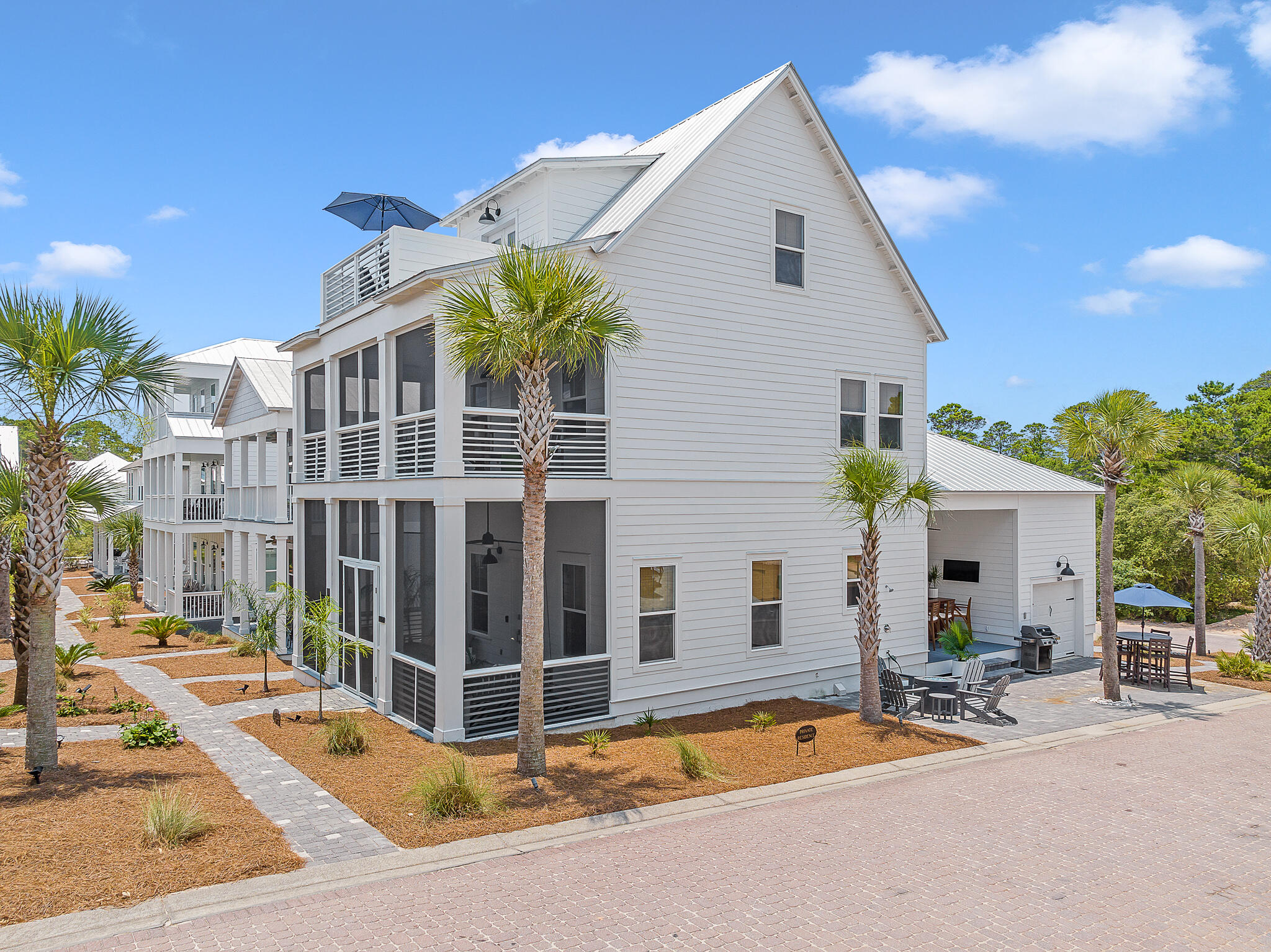 Welcome to this stunning custom-built luxury home, nestled on a corner lot, located just a short stroll from the beach. This tastefully decorated, never rented residence offers an array of desirable features, including 12-foot ceilings on the main level, designer upgrades, and ensuite bathrooms in all bedrooms. The oversized third-floor bonus room is a versatile space that can be transformed into a home office, media room, or guest suite providing endless possibilities to suit your lifestyle. This home hosts an abundance of outdoor living spaces, including a covered patio, two southern-style double-depth porches, paver patio, complete with a third-floor tanning deck!  Community pool, providing the perfect retreat during warmer days.