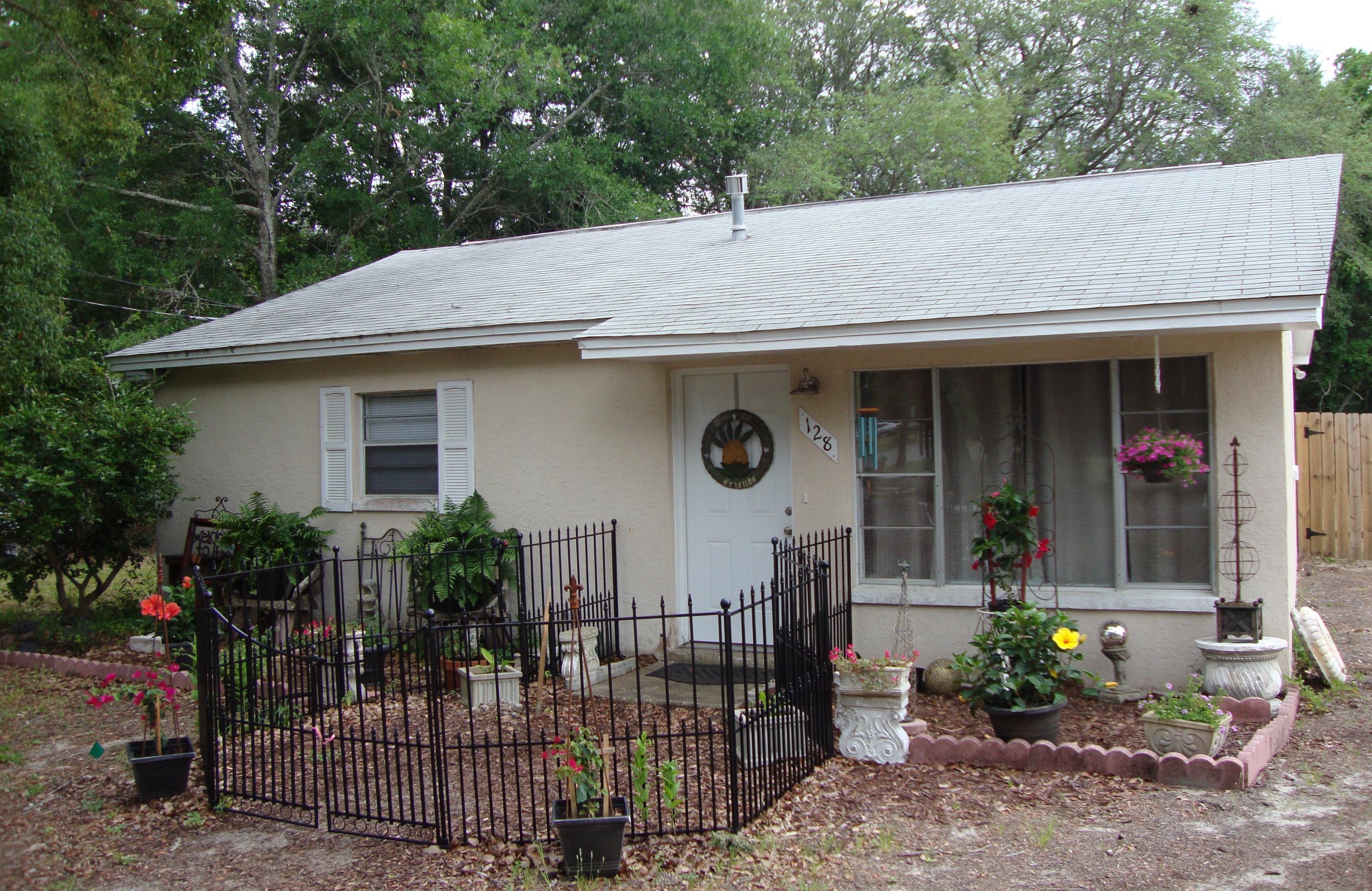 Charming, affordable 3/1 home in an established centrally located neighborhood. Surprisingly large bedrooms and eat-in kitchen; lots of yard space with mature trees. Well laid out, needs a little work to make it a showcase but very livable; add value as you make it your own.'Courtyard' fencing is modular and easy to reconfigure or remove. Bonus 10 x 14.5 storage space attached to back of house + yard shed. Copper wiring with updated panel. Newer carpet in bedrooms. Samsung French Door refrigerator w ice maker (not currently hooked up). X Flood Zone. Buyer to verify all information. Potted plants and outdoor decor does not convey.