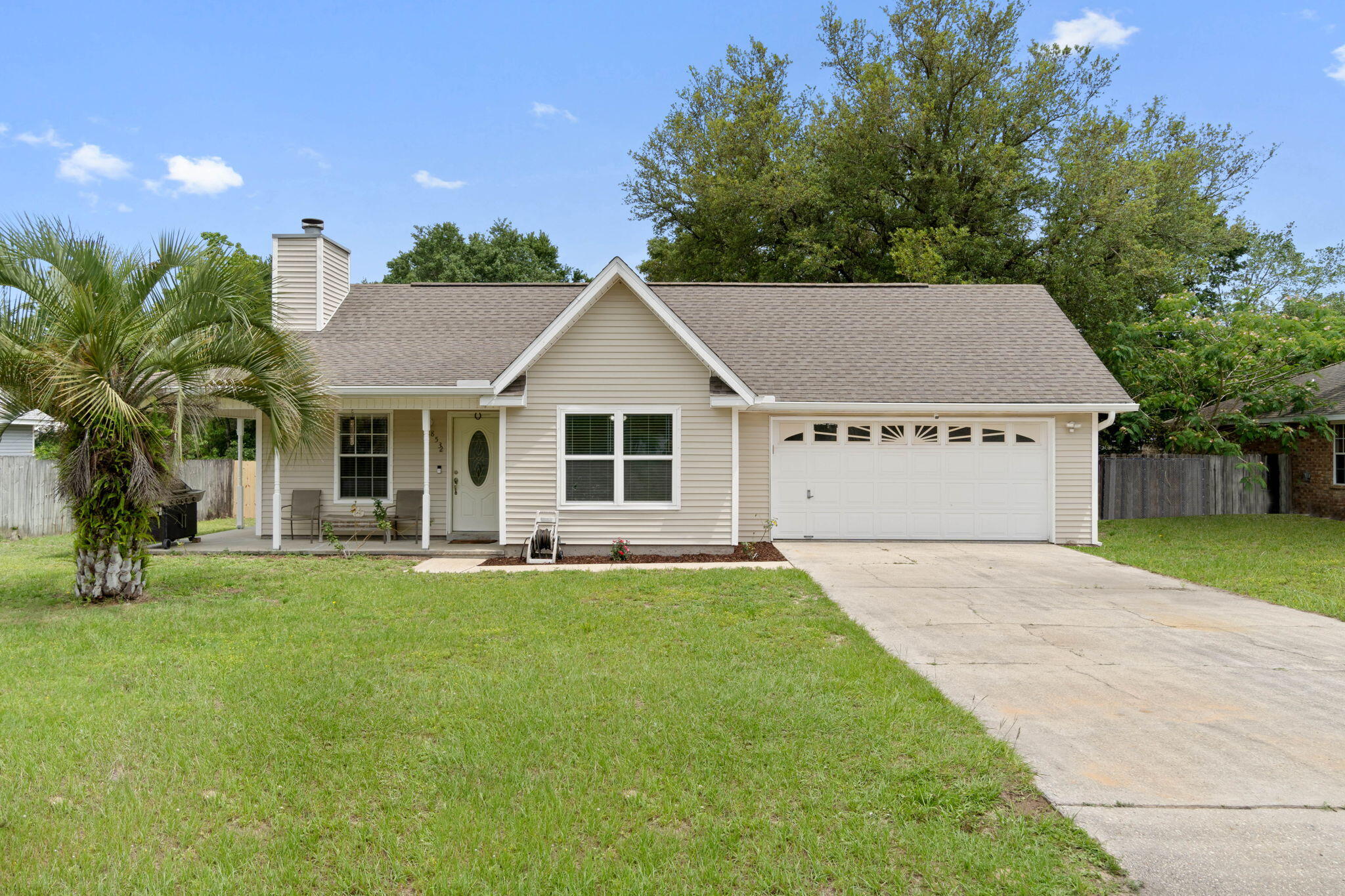 *New roof to be installed prior to closing!* No HOA! Welcome home to this delightful 3 bedroom, 2 bath ranch towards the end of the cul-de-sac with an adorable covered front porch. Located on a 0.28 acre lot in a convenient east Navarre location with a fully fenced in backyard, you'll love being only 4 miles to Navarre Beach and less than 20 minutes to Hurlburt Field!  Pull into the driveway and appreciate the extra parking space (bring your boat!) and the charming front porch. Inside you'll find a living room with a vaulted ceiling, wood burning fireplace, tile floors, and built in bookcases. Directly to the right is a dining room and the kitchen features granite counters, stainless and black appliances, tile backsplash, updated cabinets, and a pantry.  The master bedroom has tile floors and an updated master bathroom with wood look tile and a gorgeous wooden double vanity with undermount sinks and updated faucets. Outside you'll find a fantastic back deck overlooking the fully fenced in backyard and a very large storage building. Perfect for a primary home or investment property, and no HOA!