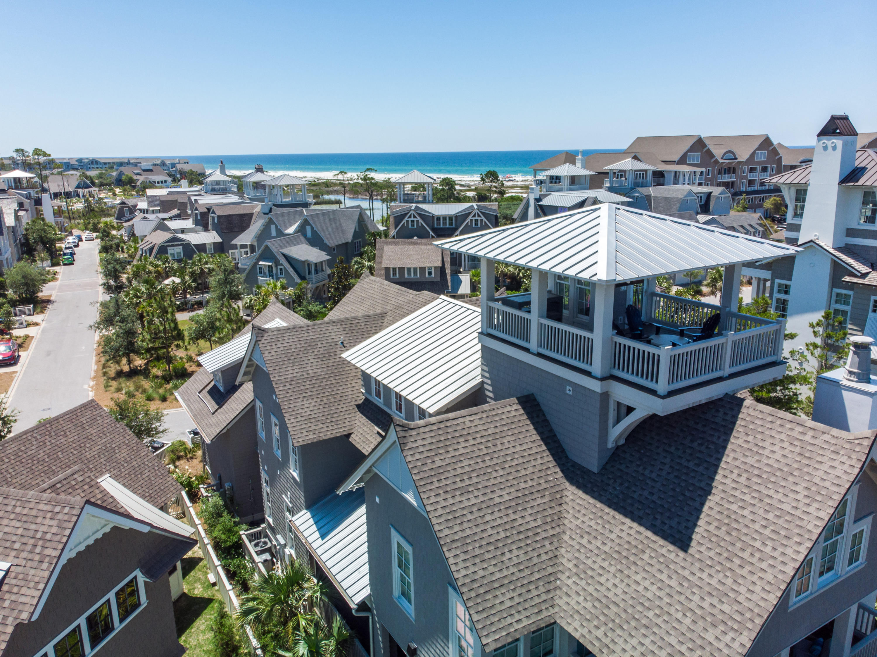 Truly epitomizing the WaterSound Beach lifestyle is a beautiful coastal retreat with professionally designed interiors & breathtaking Gulf of Mexico views. Taking full advantage of the prime location the home borders both Linear Park & Yacht Pond. This residence boasts an open floor plan, wide plank reclaimed hardwood floors, elevated wooden beam ceilings & a plethora of windows plus nano wall that allow in the multitude of natural light. The main level offers seamless indoor & outdoor living with the family room opening to a large screened porch providing additional dining space & fireplace surrounded by seating to enjoy endless beach days. A private jacuzzi tub on a secondary porch is the perfect spot to relax after a long day. The heart of the home is the gourmet kitchen which includes Chicago brick inlays accenting the Thermador appliances, custom cabinetry & large center island with marble countertops. There are two Master Suites each masterfully designed & including high ceilings, shiplap walls & spa-like ensuites.  The second Master Suite is spacious with private access to another expansive porch. Three additional guest suites all exemplify coastal vibes & feature finishes like wood ceilings & overhead wooden beams. The laundry offers double units to make washing as easy as possible.  Heading up the custom metal staircase is the playful bunk room & study.  The crowning jewel is the expansive tower boasting panoramic views of the Gulf.  An outdoor shower & covered entryway keep the sugar sand outside. A two-car garage allows plenty of storage for beach toys, golf cart & additional parking.  Gated & incredibly private, WaterSound Beach offers a mile of gulf front while still being minutes to dining & shopping.  This residence represents a rare opportunity to enjoy a property of exceptional quality & character steps away from the private white sands of the Emerald Coast.