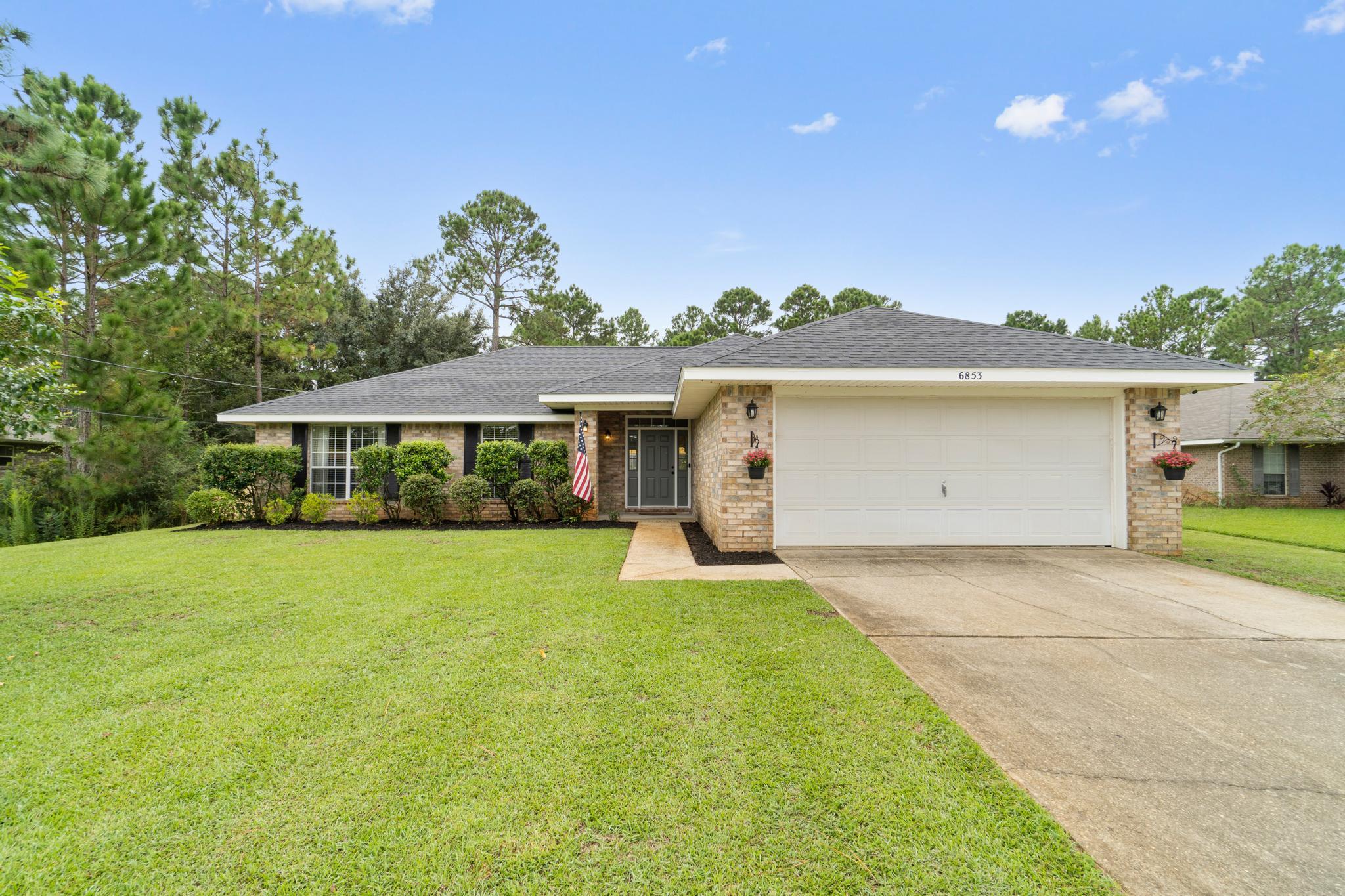 New roof 2021, new HVAC 2020, water heater 2017! Welcome to this true 4 bedroom located in the popular Navarre neighborhood of Holley by the Sea! Pull up into the driveway and appreciate the impeccable curb appeal on this fantastic 0.46 acre lot. Walk inside and tile flooring greets you that extends into the kitchen and from the entryway you'll love the open floor plan with matching tile flooring extending through the living room and find newly replaced carpet only in each of the 4 bedrooms. The spacious living room has a vaulted ceiling and is open to the eat in kitchen space, which leads to the well appointed kitchen with white cabinets and stainless appliances. The split floor plan allows for master bedroom privacy. A great sized bedroom leads to a spacious en suite with double vanities with granite counters, a walk in closet, a gorgeous walk in tiled shower and private walk in closet. One of the additional bedrooms is located off the living room so it also makes it perfect for an office, playroom, or game room! The other two nice sized bedrooms are down the hallway and share a full bathroom with an updated vanity. Outside you'll find a massive and completely cleared and fenced in backyard complete with a sunshade over the extended back patio and a zip line that will convey! Have peace of mind with termite protection from Arrow Exterminators. Welcome home!
