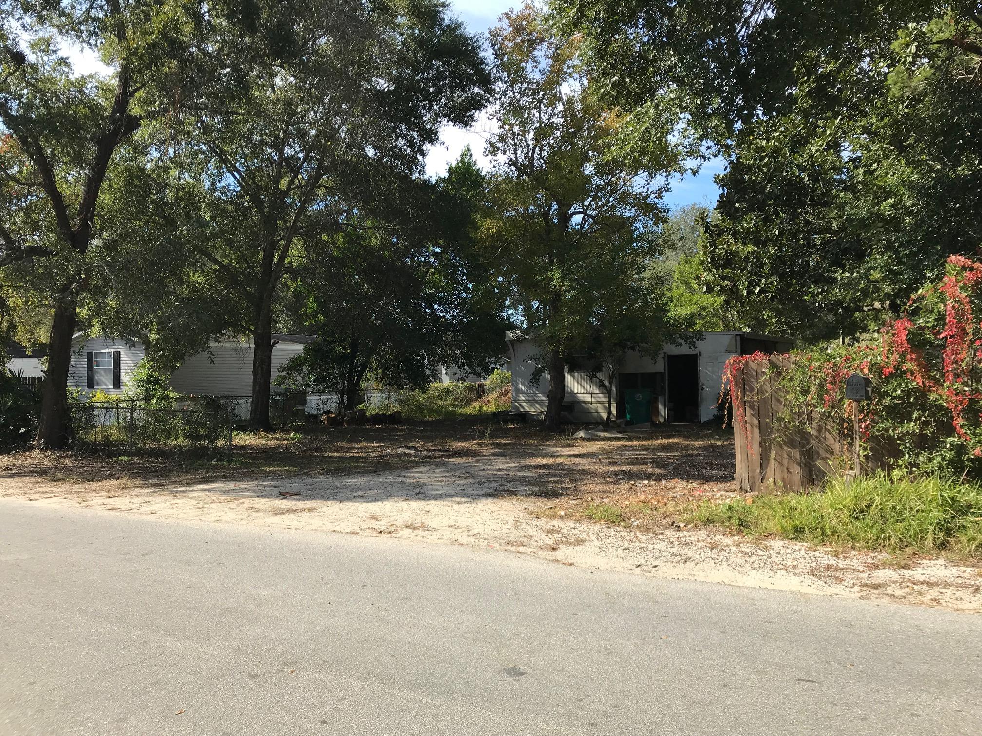 New price! Residential building lot available! Centrally located. Magnolia and large oaks on property. The mobile home on site brings no value. Please do not go inside mobile home.