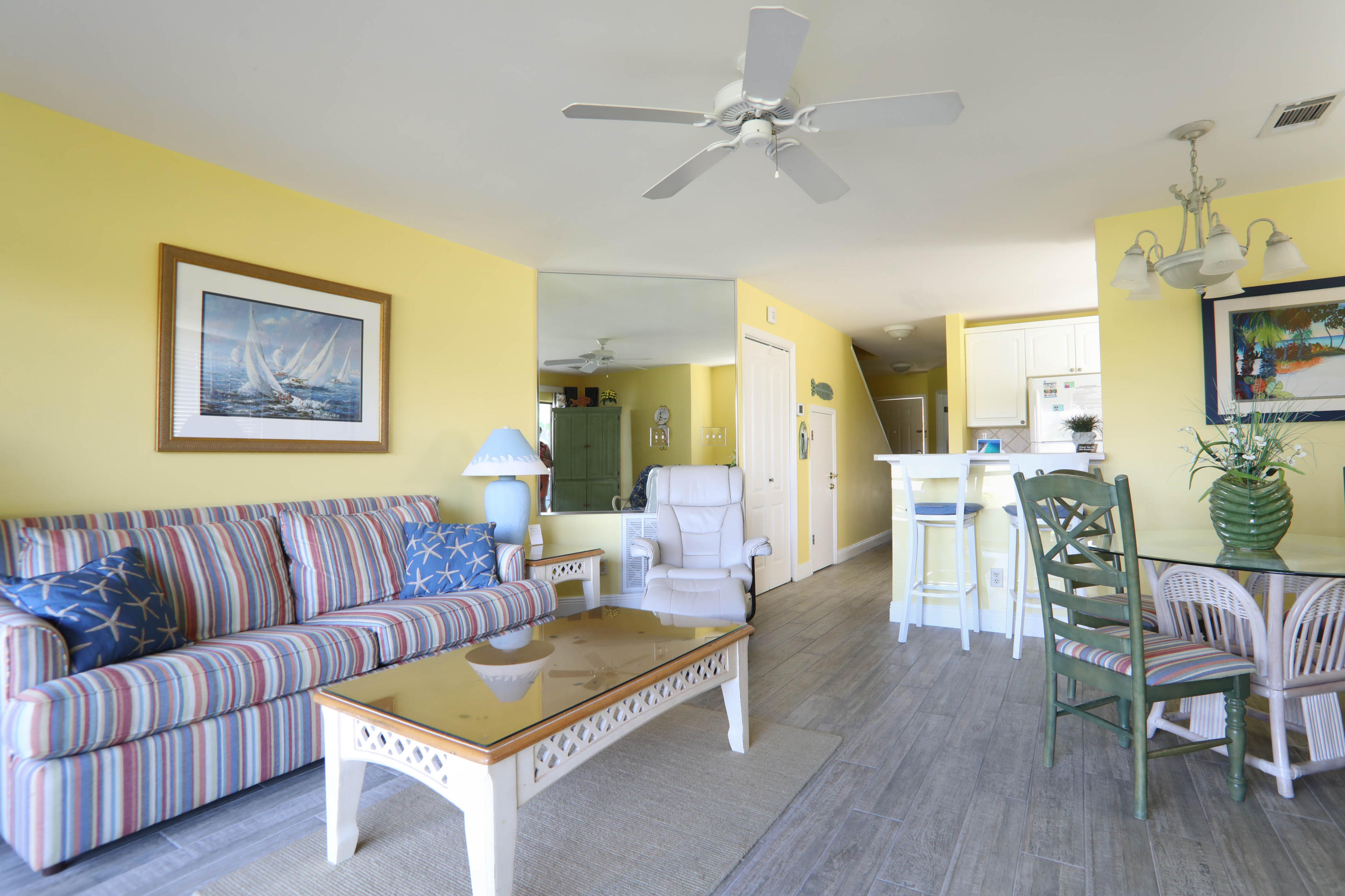 Coveted end unit townhouse in Seascape Lakefront, the area closest to the beach access. Overlooks Lake Stewart and the 14th green of the Seascape golf course. Has walk-out to freshwater fishing, or just to feed the ducks. As an end unit it has additional windows to make it light and bright. Full width glass with slider opening onto screened private patio. This two story beach home was completely renovated in 2001 and updated by current owners in 2017. It may be the quietest unit in Seascape, as the renovations included sound deadening wall insulation between it and the adjacent unit. Plus there is not another unit above or below this condo. Great rental potential.