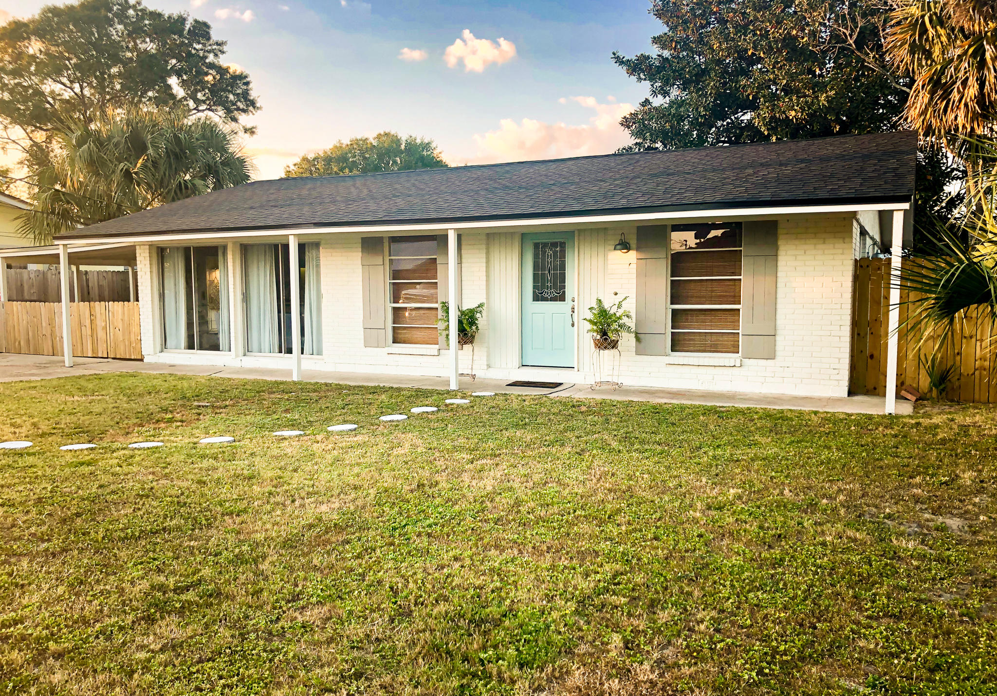 This charming 4 bedroom ranch is located just a few blocks off the Gulf in the popular Open Sands neighborhood. You can enjoy ocean breezes from the covered patio, or a game of catch, or cornhole with the family in your large fenced-in backyard...there is even room for a pool!
You'll notice fresh paint inside and out in modern coastal colors, a new roof and fencing. Interior features include bamboo flooring, updated appliances and lighting, and vaulted ceilings create a spacious feel throughout all the main living areas. The 4th bedroom located off the kitchen makes a great bonus room or guest bedroom, and it has its own full bath and separate entrance! The home comes with a small shed off the patio perfect for all of your beach gear, and a large 10'x24' storage building offering ample