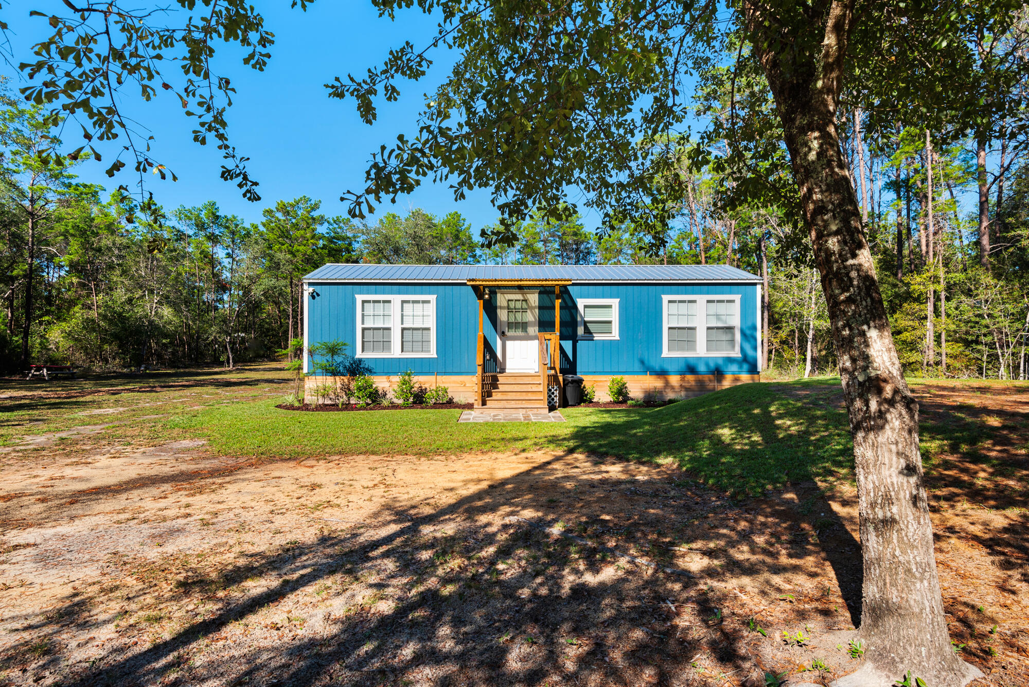 Newly constructed home nestled on over an acre of cleared land in the heart of Freeport. With utilities in place and a new septic system installed, this property offers ample room to expand—build a larger home or a second residence! This uniquely decorated home was operated as a successful short-term vacation rental with a strong rental history. Complete with hardwood floors throughout, a kitchen island, butcher block countertops, stainless steel appliances, and abundant cabinet space. This home is equipped with two ductless AC systems and hurricane proof windows. A large wood deck in the back and lovely front porch. 
This rare gem offers a blend of charm, functionality, and potential. Whether you're seeking a turnkey home or an investment opportunity, this property has it all.