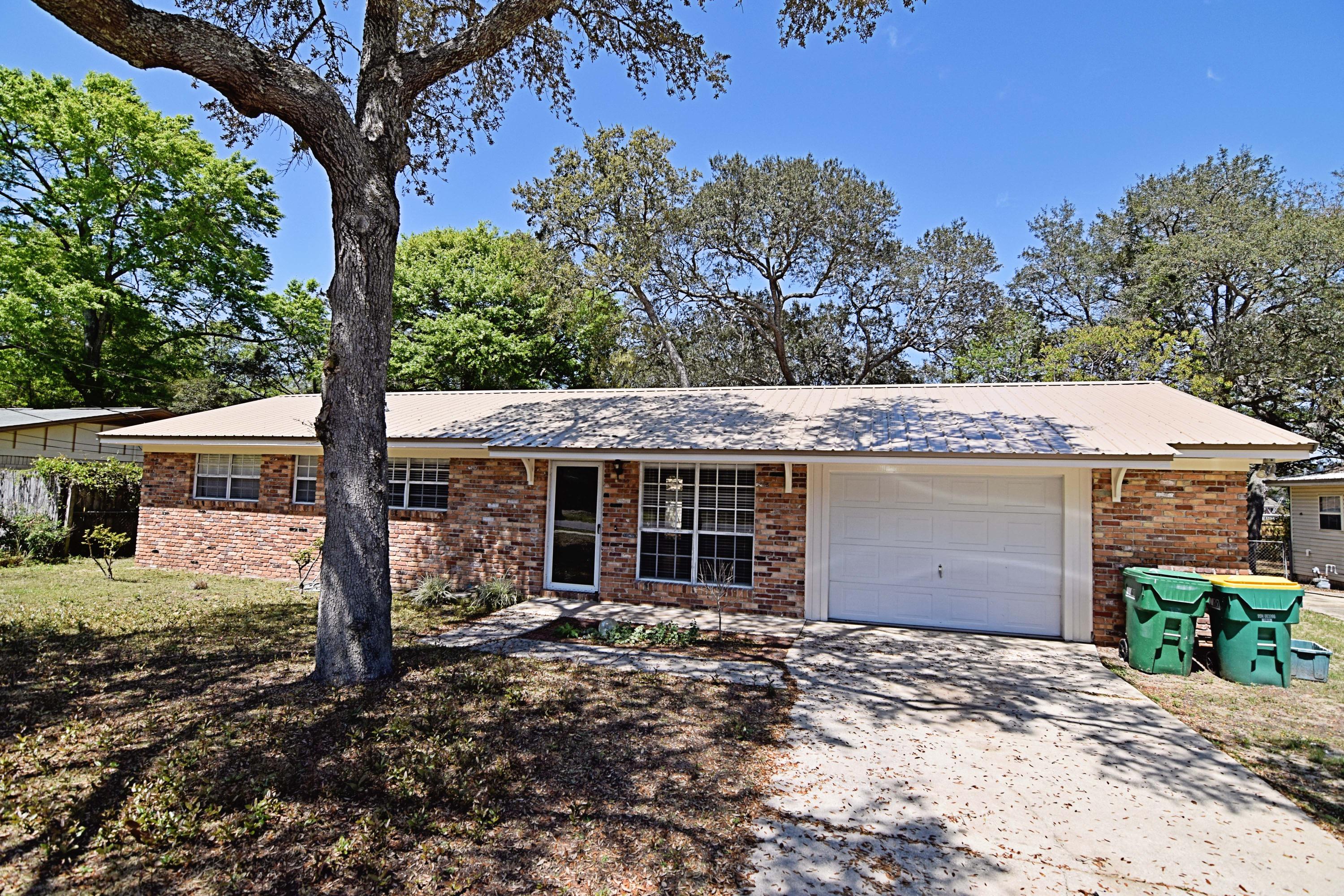This all brick home has 2 bedrooms and 2 full baths. Enjoy the fully fenced back yard from the deck just off the tiled Florida room. The many trees provide lots of shade even in the heat of the day. There's a large shed for your latest hobby storage too. Parquet wood throughout. Kitchen has all the appliances you'll need to get cooking, and there is even a washer and dryer. Located in the heart of Niceville on a quiet street this is a must see. Owner will consider a pet that is spayed or neutered and fully housebroken with a non refundable pet fee and a refundable pet deposit. Call our office today to schedule your showing appointment.
