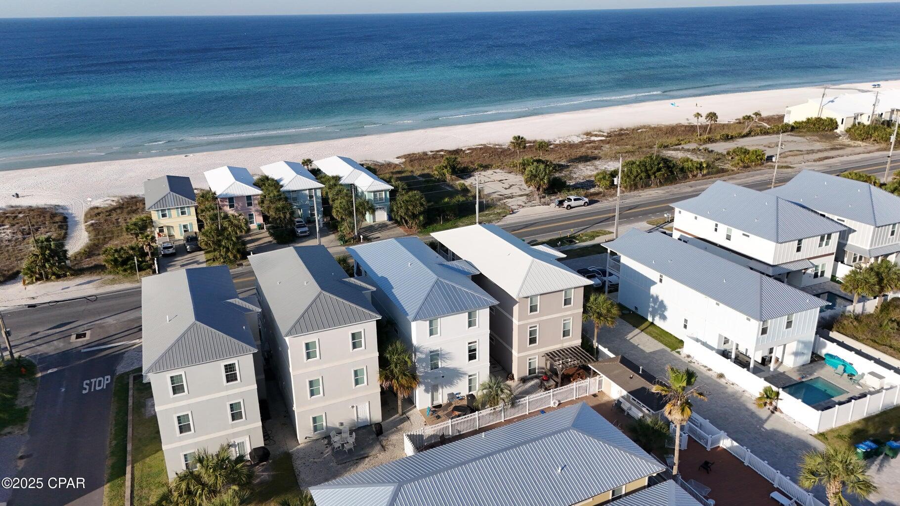 Beach house with stunning views of the gulf and beach. This three-story home features 5 bedrooms and 5 baths. It is a rental machine generating six figure rental income. There is a community pool behind the house. Garage has been transformed into a game room. There bunk room on main level to accommodate large groups. The exterior has a fresh coat of paint.