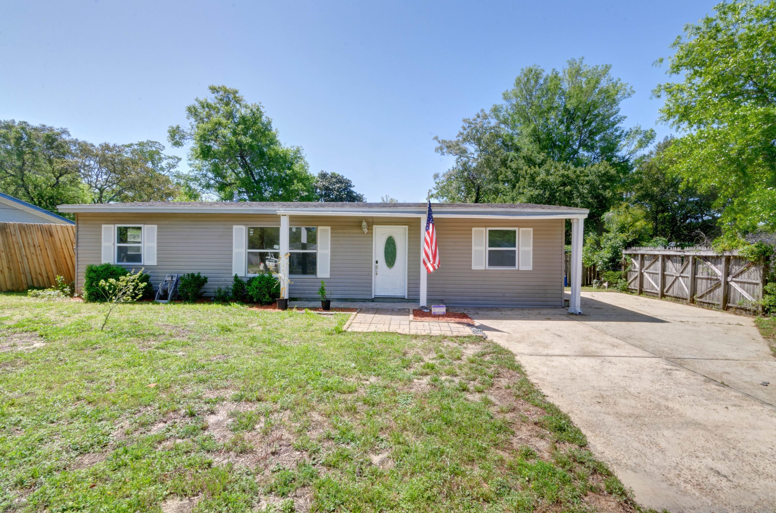 Adorable and affordable! This renovated home, perfect for a primary residence or investment property, is situated on a quiet street in the heart of Fort Walton Beach conveniently located to Hurlburt Field and Eglin AFB. Appreciate updates like all new electrical and new windows. Outside you'll love the extra concrete pad for extended parking space and in the large backyard a newly built back deck has plenty of room for entertaining. Inside, the living room has a large picture window allowing for plenty of natural light within a vaulted ceiling.  You will love this eat-in kitchen with lots of new cabinets, plenty of counter space, upgraded stainless steel appliances, a pantry, and tile flooring throughout. The master bedroom has a vaulted ceiling and a recessed wall for an entertainment center or dresser, and the master bath has tile flooring and a tiled walk in shower in addition to the newly installed tankless water heater and washer/dryer hookups. The split bedroom floor plan allows you additional privacy with two additional bedrooms and a full bath on the other side of the home.