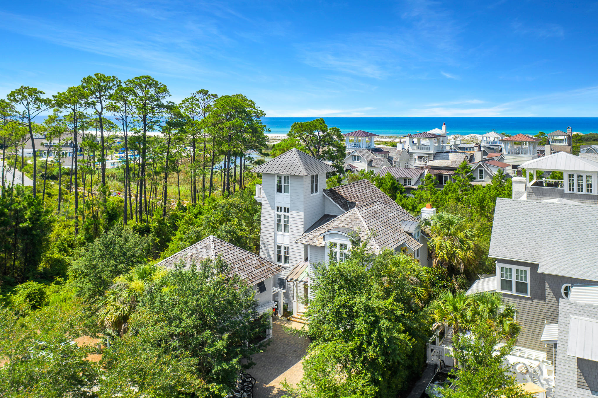 Nestled within Watersound Beach, this refined home offers a highly desirable combination of Gulf Views, Proximity to Pristine Beach Access and the Relaxed Lifestyle of the Watersound Beach Club. Seller will pay membership fee for an all-inclusive, unlimited golf and beach club membership to the Watersound Club.
In the classic Nantucket style Watersound is renowned for, this classic home designed by Tom Christ Architects has been appointed with luxury furnishings, custom lighting, home automation and elegant finishes. The double height raftered family room adds to the sense of light and openness. The first floor provides a fabulous kitchen with pecky cypress detail, separate media room with bar and a fabulous owner's suite. The second floor contains three spacious bedrooms including a second owner's suite with beautiful views of the gulf. The 3rd floor tower provides stunning gulf views and is a perfect spot for sunset. Outdoor spaces abound with a screen porch and a private back yard with lush landscaping. The delightful carriage house provides a well-appointed private luxury retreat complete with kitchen, living and sleeping spaces. The oversized garage and drive offer plenty of parking.