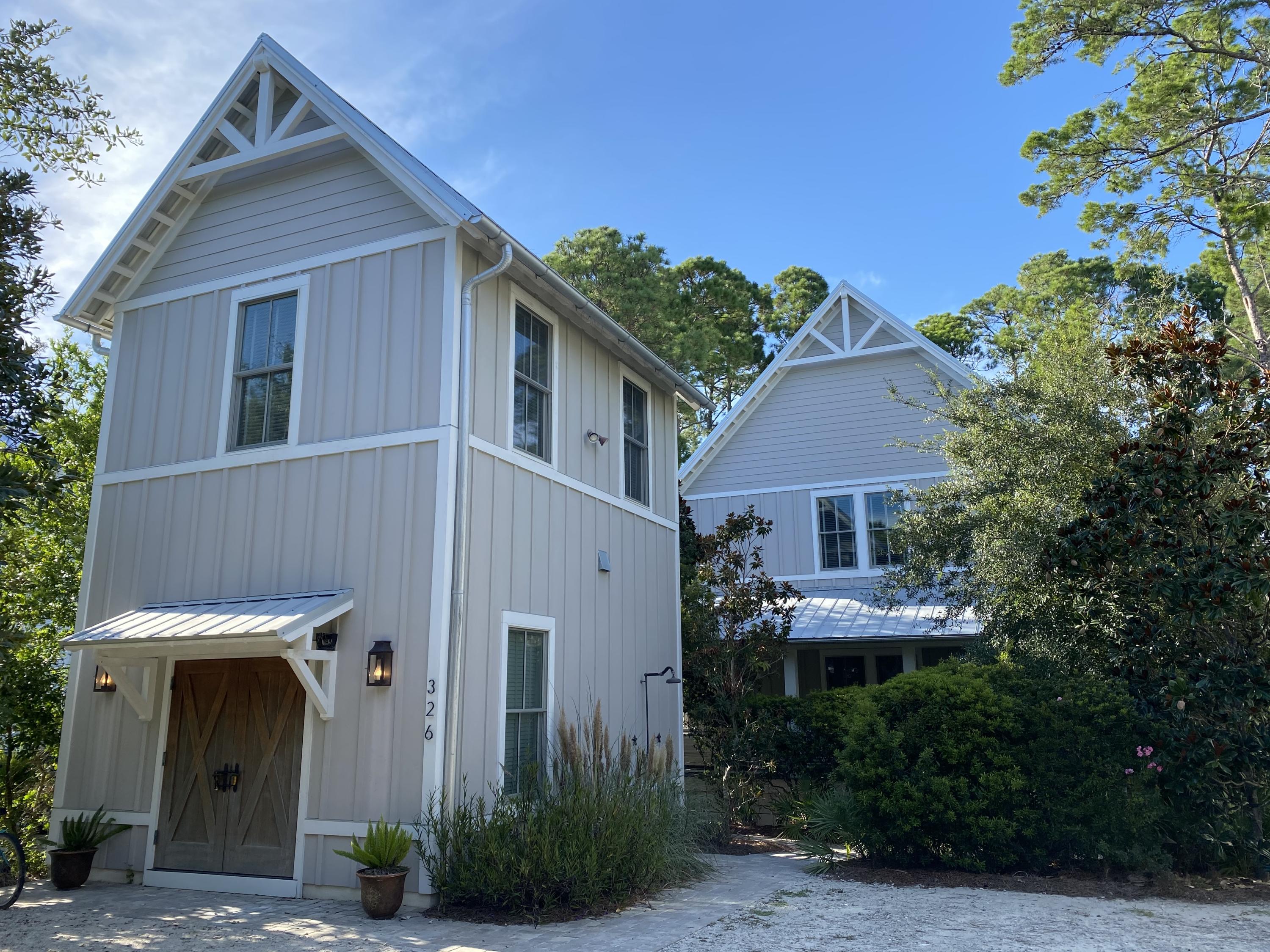 3 minutes to Seaside town Square, 3 minutes to not just 1 but 3 beach access is located in the heart of our beloved old Seagrove! 326 Canal St. is located on a 'no outlet road.' 0.23 acre lot on the canal that gives you access to one of our unique coastal dune lakes via kayaks: Western lake which leads to Grayton beach. This 3689 Sq Ft beach cottage hosts 5 bedrooms 4.5 baths, detached carriage house, oversize bedrooms, large screened in porches, ample storage and a 220 outlet for an electric car. Upon arriving to this beautifully maintained home - you are greeted by appealing greenery and beautiful barn doors on the face of the detached carriage home that lead into a heated and cooled storage area.  Following the path passing the outdoor shower is the entrance into the spacious kitchen in the carriage home with butcher block style counters. A full bathroom is nestled under the stairs leading to the large main carriage room. 

Continuing down the path outside, you're guided to a large L-shaped porch where a hanging bed swing, rocking chairs, gas lanterns and decorative plants reside, welcoming you to the entrance of the main home. The incredibly spacious great room has a natural gas fireplace, wet bar complete with a wine fridge, stainless steel appliances in the kitchen and open formal dining area. On both sides of the fireplace are french doors that open to your first screened in porch with dining and casual lounging area. The screened porch opens to a platform hosting an entertainment area with a fire pit, exposing you a red tree swing sitting in the lush vegetation on the canal. On the first floor a large owners closet sits behind the kitchen, A half bath, a large bedroom with walk-in closet and extra storage as well as an en suite bath. Upstairs, a long hallway leads to a full bath, 2 spacious bedrooms, laundry with a refrigerator and the primary suite. The primary suite with tray ceiling and accent lighting and primary suite bath with a freestanding tub and large shower, both have access to the second screen porch complete with a swinging bed and casual lounging areas that overlooks the Canal and the Western Lake Drive bridge in Watercolor. 326 Canal Street it's a perfect vacation/2nd/primary residence in a quiet neighborhood with no HOA. Furnished with exclusions, turn key!