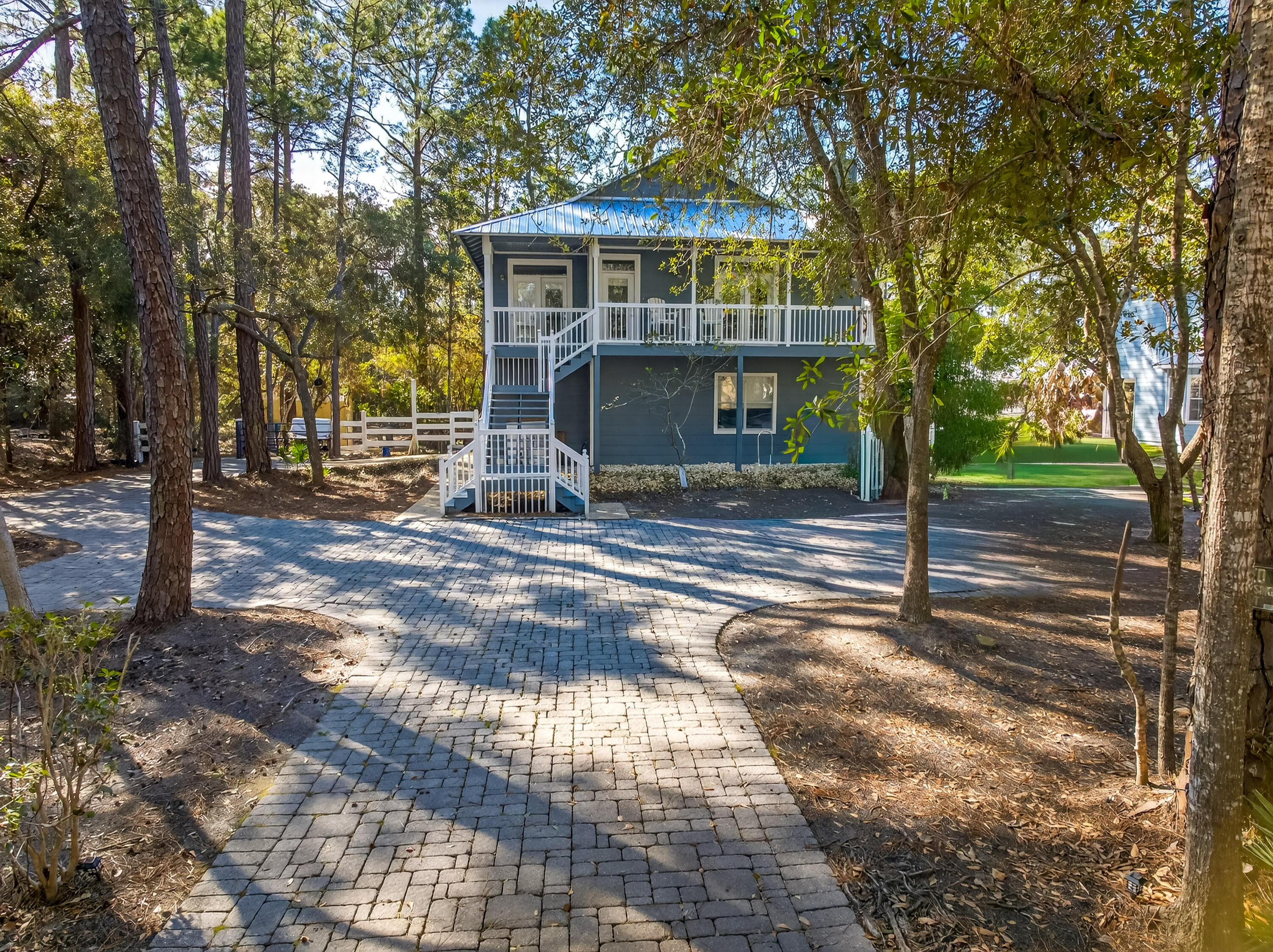 Set on a generous .6-acre property in a peaceful, natural setting, this 4-bedroom, 3-bath home offers a rare chance to create something truly special. Backing to tranquil woods and just a short walk to the bay. 
NO HOA! 
The paver driveway leads to this charming home with solid bones, ready for updates and personal touches.  
First floor includes 2 bedrooms and bathroom.  Additional storage space adjacent to garage. 
Main level on 2nd floor offers open kitchen and living area with fireplace, primary bedroom and bathroom and an additional bedroom with ensuite bath.  
Two spacious screened-in porches invite you to slow down and enjoy the surrounding nature, offering wonderful outdoor living spaces with endless potential.  
New roof 2025. With room to reimagine and enhance, this is ideal for buyers looking to add value and make it their own. Home is being sold AS IS. The combination of .6 acres, wooded privacy, and bay proximity is increasingly hard to findbringing vision and creativity will unlock the full charm of this hidden gem.