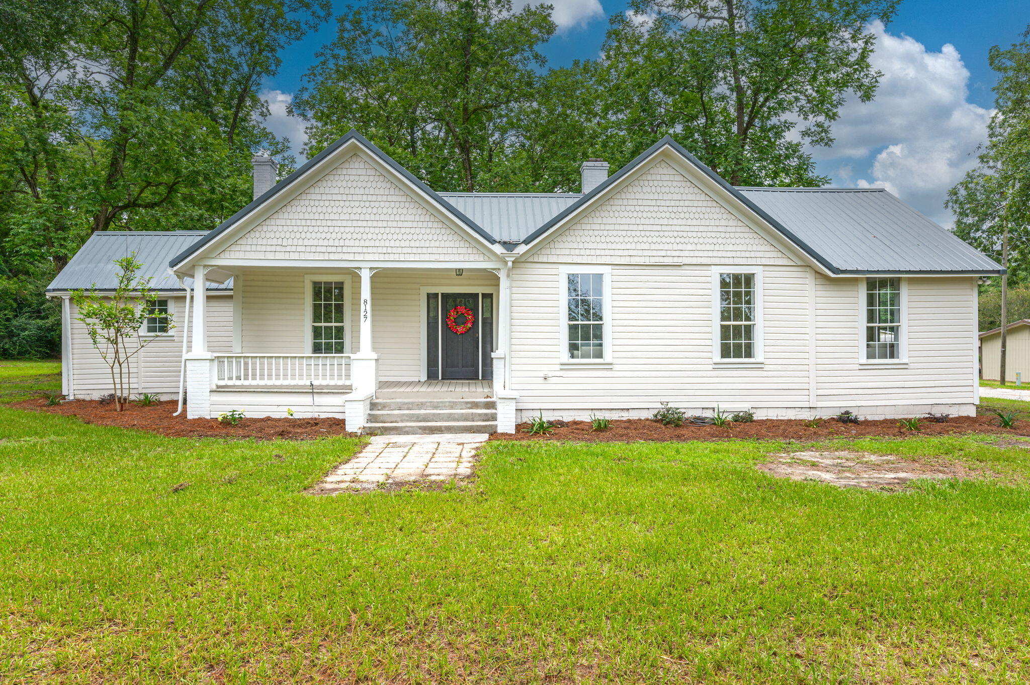 This historic home has undergone a full renovation with not one detail overlooked! All of the original hardwoods have been restored throughout the vast majority of the home. New sheetrock was added through the entire home. Each of the three bedrooms have a fireplace. The fourth room could be used as a bedroom, office or playroom and has an abundant amount of natural light. The master bathroom has been reworked to include an oversized walk in closet, a tiled shower with custom glass doors and a double vanity with a linen closet and quartz countertops. There are a total of two and a half bathrooms. The living room is truly a GREAT room with a fireplace and room for casual seating plus a separate conversation area. The kitchen displays new ceiling height cabinets with soft close drawers, quartz countertops, tile backsplash, a farmhouse sink with garage disposal and new stainless steel appliances. Off of the kitchen, is a large laundry room with upper cabinetry and brick floors that run through to the half bathroom. The entire interior and exterior of the home were repainted. There are three porches outside overlooking the oversized yard which is full of beautiful mature pecan trees.
