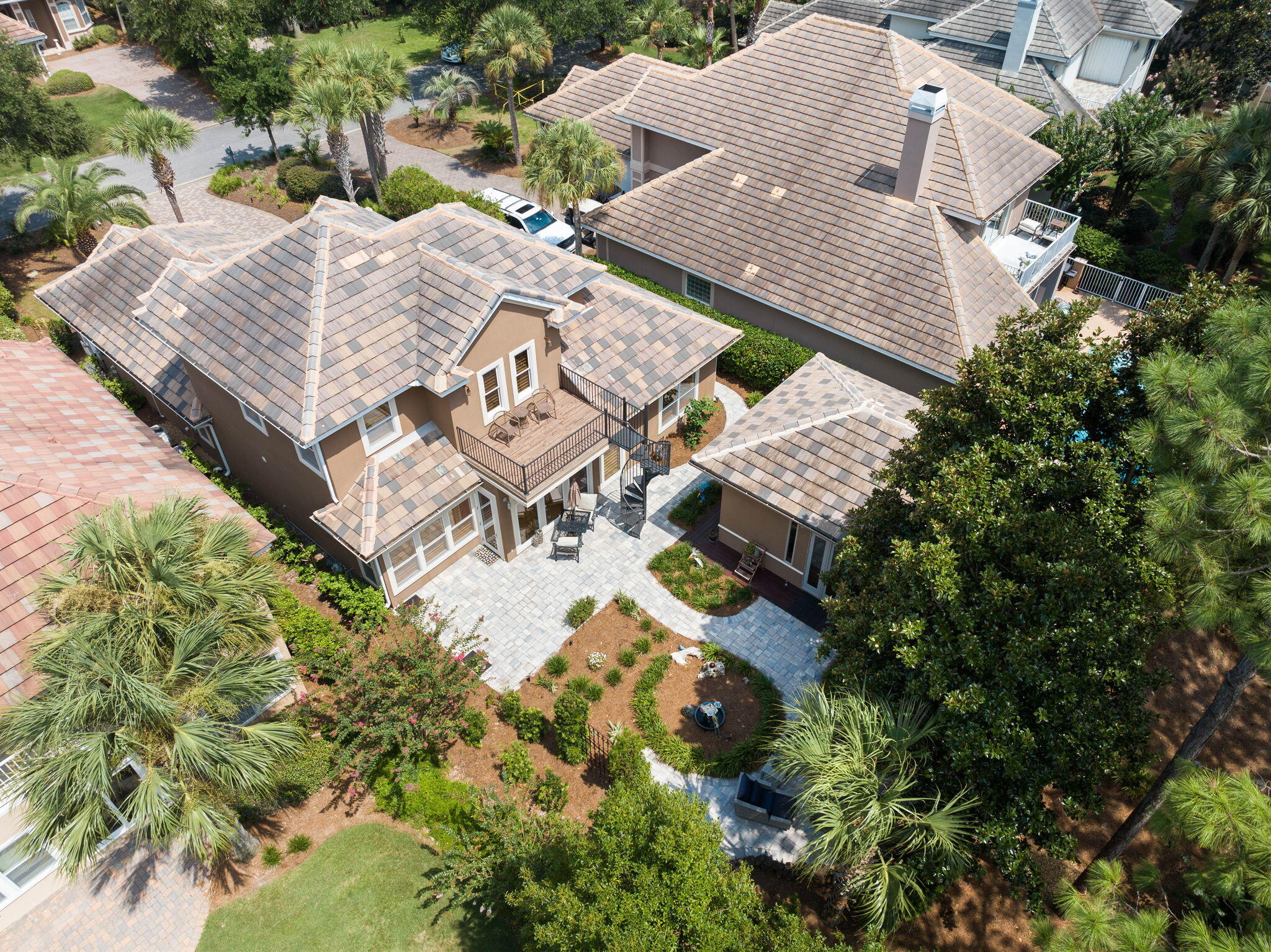 This beautiful home is unique with its main house along with carriage house and is located on the 5th tee box in the highly revered neighborhood Regatta Bay. The main home boasts an open floor plan, first floor master suite with a tranquil spa like bathroom, and living area adjoining a Florida room with gas fireplace. The kitchen is open to the living and dining room and features new appliances, sleek quartz countertops, cast iron farmhouse sink, and backsplash. Upstairs has two bedrooms, each with an ensuite bathroom and large walk-in closets. Outside, there is a separate carriage house with a large open area, built in desk, closet, and half bath. The room is ideal for visiting guests, fourth bedroom, a study, man cave, future pool house, or craft room. The backyard features lush landscaping and pavers leading out to a natural gas firepit overlooking the golf course and has room for a pool. This remarkable home is situated within the only gated community north of 98 in Destin with direct golf cart access to the beach. Take a dip in the sparkling community pool, challenge friends to a game of pickleball or tennis, or watch the little ones have a blast at the playground. Golf enthusiasts will appreciate the convenience of having a golf course right at their doorstep, along with the clubhouse to meet up with friends and enjoy watching the game.  The property's location is near the bay and it's just a leisurely golf cart ride away from the beach, allowing you to soak up the sun and enjoy the coastal lifestyle.  Life like you are on vacation every day!