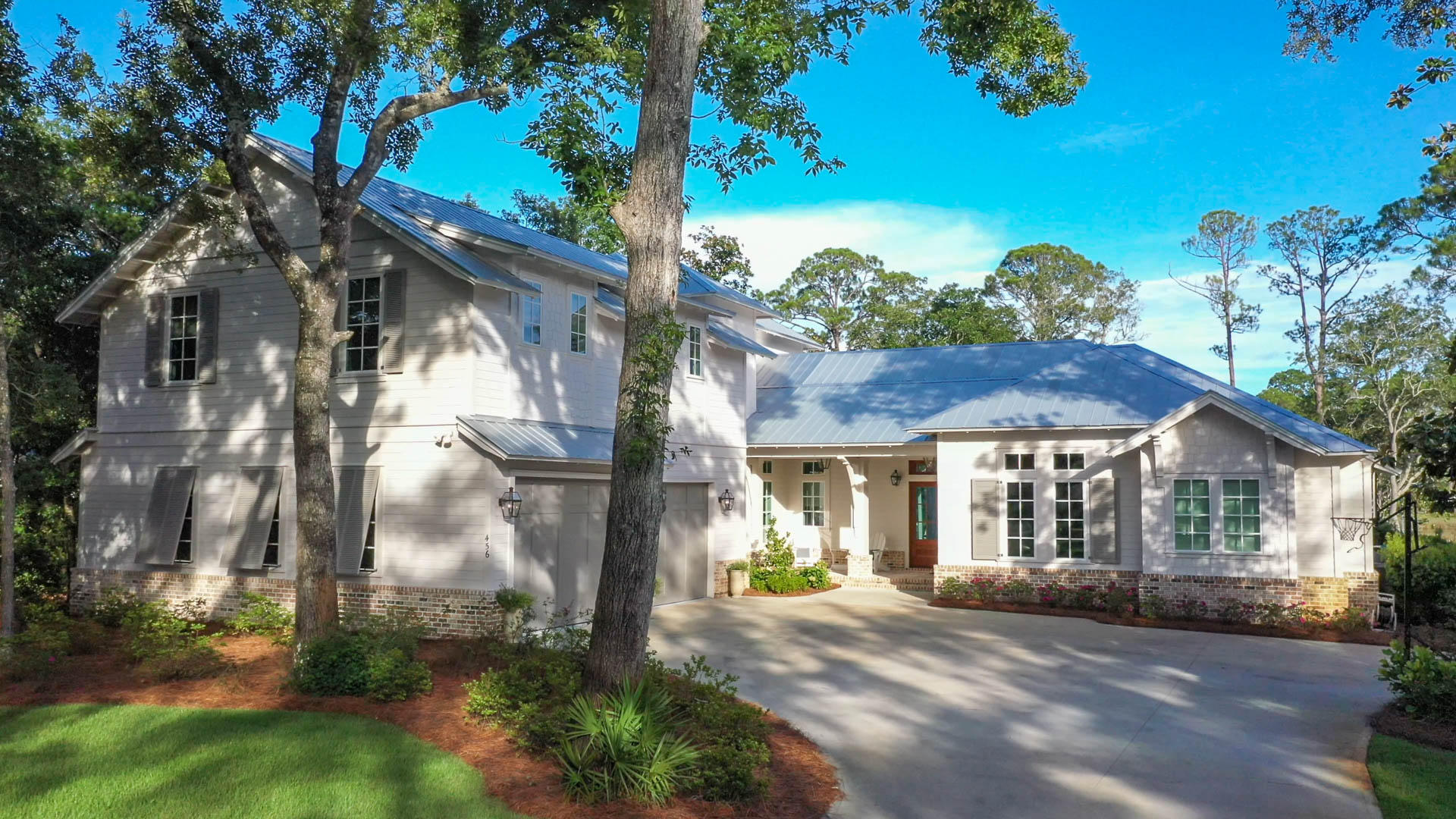 Botany Bayou is a secluded, gated neighborhood filled with live oaks on Hewitt Bayou, close to all the necessities of life. This custom-built home with 100' of water frontage has it all including a covered dock with two boat lifts and a private saltwater pool. The entry way with its circular wall of windows allows your view to extend over the pool, through the lush backyard all the way to the water. The 14' vaulted ceiling with reclaimed hand-hewn beams from an old barn in Wisconsin crown the dining living room. Calcutta Gold marble along with Subzero/Wolf appliances, coffee/cappuccino maker and steam oven make entertaining a breeze. The outdoor living & dining areas with fireplace, outdoor kitchen and lounging area overlook the pool. Master bedroom with striking Snow White marble, soaking tub, dual head shower with bench seat, along with a private office and laundry room with storage galore complete the main floor. Upstairs bunk/media room, three guest rooms with private baths makes this 4,488 square foot home ideal for you and your family. Eric Craig with B. Design of Destin - Architect