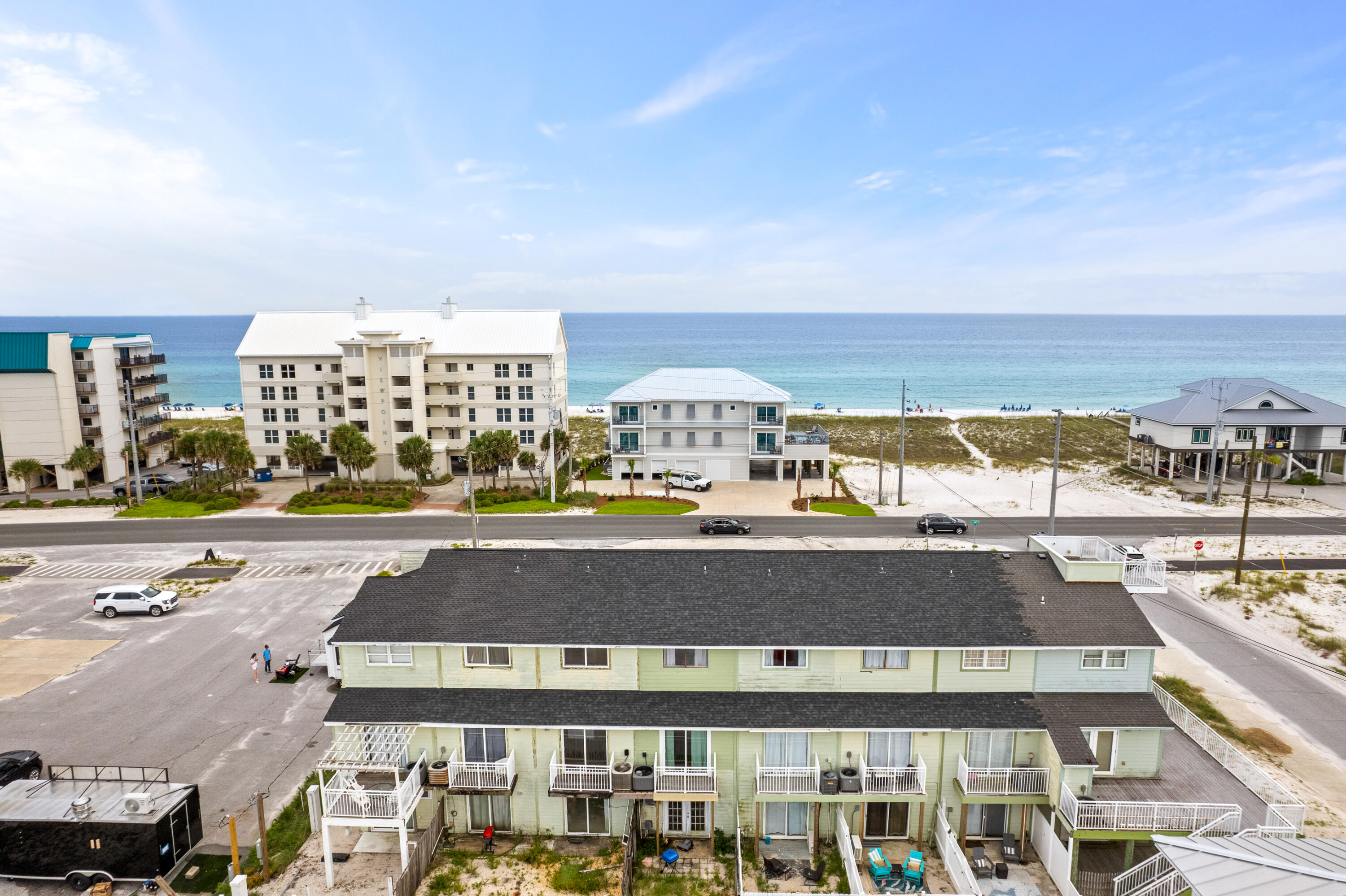 Unique Lockout Unit with Water Views of Navarre Beach with a studio on the first floor and 3 bedroom/2 bath unit upstairs on the 2nd and 3rd floor!! You can rent them as one unit with 4 bedrooms or two separate units! NO HOA!! Over $47,000 in rental income for 2023; over $42,500 
 already received for 2024!!

The ground floor houses a full-size studio with a sliding glass door leading to a fenced-in, uncovered back patio. This studio unit includes a fully functional kitchenette including a small refrigerator, a stove, and a new microwave, along with a full bathroom, making it count as the fourth bedroom in the MLS listing. Separate access ensures privacy and convenience.

The main unit spans the second and third floors. On the second floor, you'll find a guest bedroom with a private balcony overlooking the fenced patio and a balcony off the main entry door, perfect for enjoying morning coffee or evening wine with water views of Navarre Beach. The third floor features the master bedroom with a private balcony offering stunning water views of the beach, a third bedroom with double bunk beds, and a full bathroom (one on each floor).

This townhome comes with a covered carport and one deeded parking space, and it is part of a small, exclusive complex with only seven other units. The covered carport includes shelving and hooks for beach supplies and rafts, and there is a shared outdoor shower area for both units. Additionally, a shared laundry room with a new full size washer and dryer is located in the foyer area on the first floor. It is located just 0.3 miles from the beach access, it's a short six-minute walk or one-minute drive. 

The property is turnkey and rental-ready, sold fully furnished, with existing reservations on the books that can be transferred upon the sale. The roof was replaced in 2021, ensuring peace of mind for new owners. Situated directly across the street from Navarre Beach, this townhome is close to multiple restaurants, including a new Starbucks and Buffalo Wild Wings, and numerous public beach areas, making it a popular vacation spot for families and friends. Don't miss the opportunity to own this versatile, income-generating property in beautiful Navarre Beach, perfect for investors or those seeking a beachside getaway!