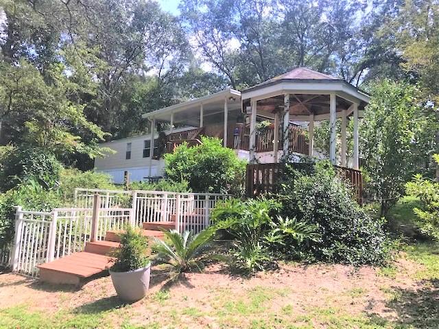 This is great and affordable lakefront home on King Lake (300+ acre fishing lake)! This 1.6 acre property is completely fenced, with exception to the water frontage. If you're an outdoor enthusiast, you'll love this place! Lots of flowering trees & shrubs; Open front deck; screened porch opening to partially covered & open back deck; Covered gazebo; 20x20 carport; 12x24 workshop w/ power & water. A large portion of the dock is covered and even features an enclosed & air conditioned area for making it a full day at the lake in comfort. Some of the best fishing around (bass, brim, catfish). There's even the Hidey Hole storm shelter! The home is cozy and neat with split bedroom floor plan, laundry, spacious family area & eat-in kitchen. New metal roof 2015. Schedule today before it's gone!