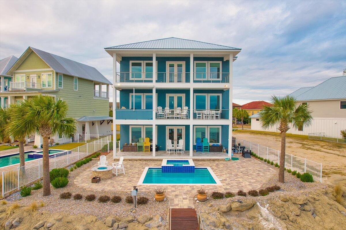 Welcome to your dream waterfront paradise at The Pointe - a hidden gem nestled in a small, exclusive gated community on the pristine shores of the Choctawhatchee Bay in Shalimar, FL. If you've ever yearned for a life on the water with stunning panoramic views, sunrises, sunsets, boating adventures, dolphin watching and luxurious living, this 4290 sq ft, 4-bedroom, 4 bath 1 half bath masterpiece is calling your name! As you enter, you'll immediately notice the sheer quality and attention to detail that defines every inch of this home. Woodgrain tile flooring runs seamlessly throughout, setting the stage for elegance and easy maintenance. With an elevator servicing all three floors, this abode caters to the convenience of modern living, making it accessible to everyone. The house has been updated with fiberoptic internet for the fastest upload speeds possible. The first floor is a haven unto itself, featuring two spacious bay front bedrooms, kitchenette and living room with incredible water views that will have your guests never wanting to leave. This level also boasts a full handicap accessible bathroom and a full bathroom. French doors lead you to a covered porch. Picture yourself sipping your morning coffee while watching the bay come to life or enjoying a nightcap as the sun dips below the horizon.

Venture up to the second floor, and you'll be greeted by breathtaking water views from every angle. The living room, adorned with expansive picture windows, connects seamlessly to a large balcony, where you'll find the perfect spot to unwind, entertain, grill out or simply soak in the serene surroundings. This dream kitchen is complete with white cabinets, stunning leather granite countertops, a convection cooktop, and recessed lighting. A walk-in pantry adds an extra touch of practicality, making meal preparation a breeze. There is a bedroom with full bath and a conveniently located half bath for guests.

The entire third floor is a primary bedroom haven. Wake up to glorious water views, with recessed lighting setting the mood for your day. Two spacious walk-in closets plus a dedicated storage room provide ample storage. The master bathroom is a spa-like retreat, boasting tile flooring that expands into the stand-up shower with a waterfall shower head, a separate soaking tub, and a dual vanity with marble countertops. There are two rooms that can be off the primary bedroom that serve as his and hers computer rooms. French doors open to an expansive covered balcony 

But it's not just the inside that will capture your heart. With 72 feet of Bay front property, you'll have a private dock, featuring two boat lifts and a fish cleaning station. The back yard also boasts an inground gunite pool/spa and gas firepit. You'll have unrestricted views access to Choctawhatchee Bay from anywhere you choose.  Whether you're a boating enthusiast or simply love the idea of spending weekends exploring the crystal-clear waters, this is the perfect launchpad for aquatic adventures including crab island, numerous boat accessible restaurants intercoastal waterway and Destin Pass.
