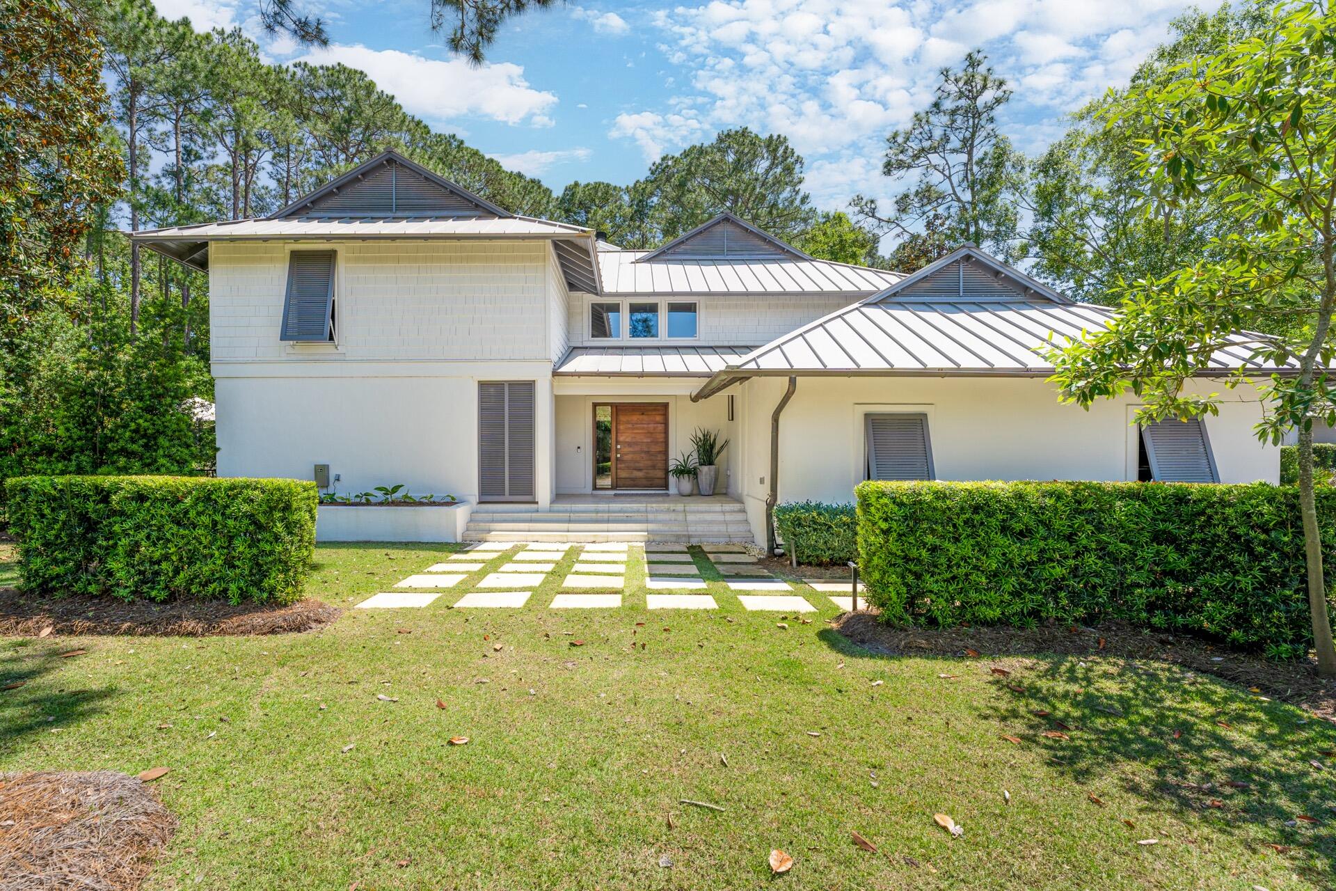 Tucked in the Pines at the Exclusive Gated Enclave of Burnt Pine at Sandestin Golf & Beach Resort is where you find this PRIVATE 3BR/3.5BA home with Bunk Room Refreshingly Unique in Design, Simplicity of the exterior reveals a touch of Modern Esthetic. As you approach the Entry and the Fabulous Oversized, Custom Hickory Front Door with it's polished nickel hardware, it is apparent you have arrived somewhere stylish.
As you enter the Open Living Area...only a soothing, sophisticated backdrop of floor to ceiling windows,neutral color, luxurious white Peacock Paver floors and clean, uncluttered lines.. The Main Living Area leads you up the stunning white stone oversized staircase. Home has a Private Master Suite, Spectacular Pool, Outdoor Living Area & Full House Generator. SOLD FURNISHED