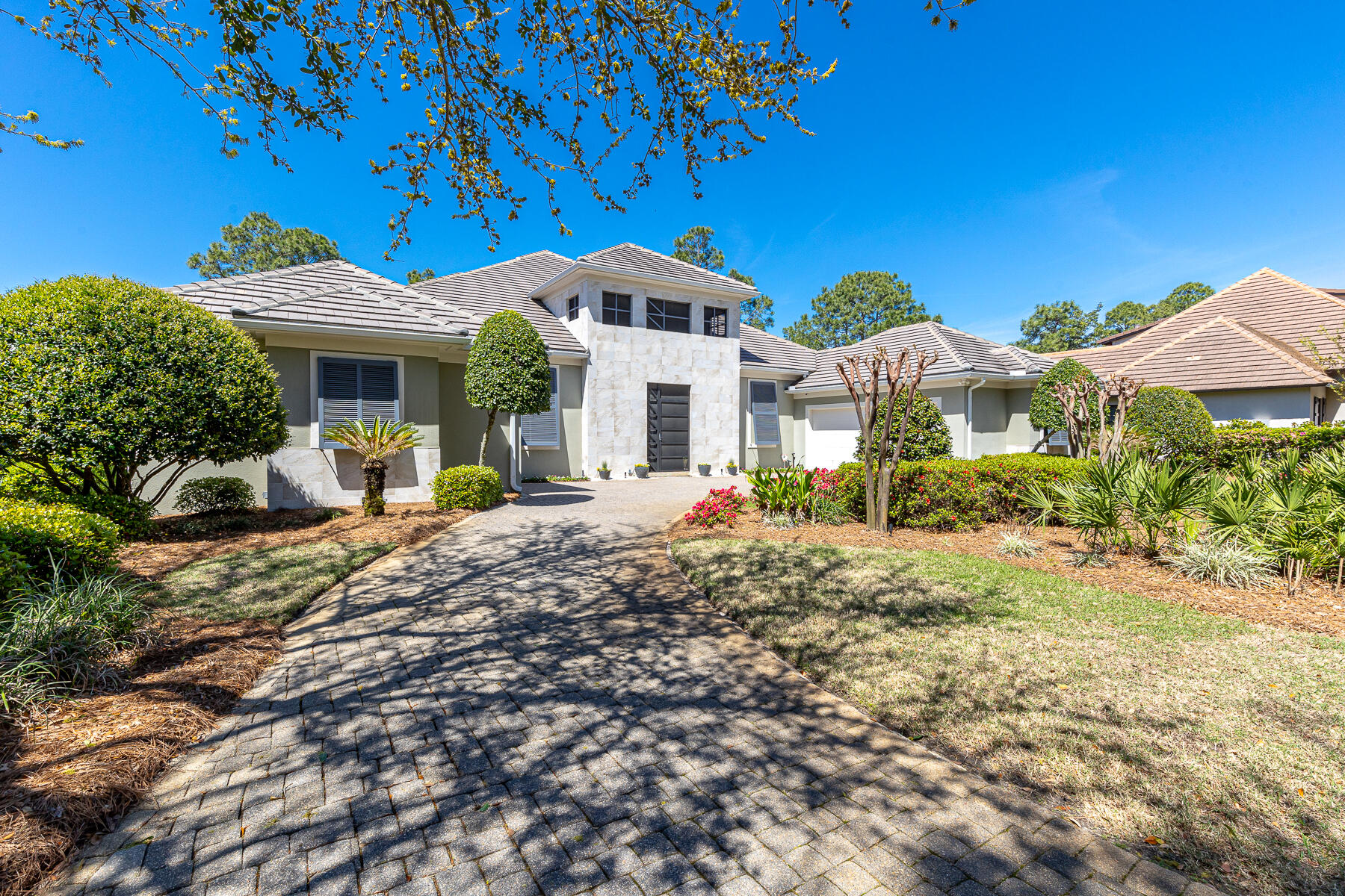 PRICE REDUCE! Seller is found another home.   Nestled in the heart of Sandestin Golf & Beach Resort's esteemed Island Green. This home stands as a masterpiece of contemporary elegance, offering a coveted lakefront position with breathtaking views over the 5th hole of the Raven golf course.
Upon entering, the home unfolds into a grand lanai, the epicenter of outdoor living, featuring a heated pool and hot tub, perfectly crafted for both serene relaxation and lavish entertaining. Unique to this property is a private carriage house, complete with a spacious bedroom, bath, morning kitchen, and its own garage. New Washer/Dryer, Wine Cooler, 4 New TV's,  2 New Dishwashers, New pool Heater/Filter, 3 Newer HVACs.  New Gas Stove Top ,New Refrigerator/guest house. New Sound System.  The main residence epitomizes opulence, with every detail meticulously selected to radiate sophistication and comfort. Interiors boast granite countertops and high-end appliances in a chef's dream kitchen, including two new dishwashers, new refrigerators, and a new gas range, while living spaces are adorned with 10/12/14-foot ceilings, custom closets, and fireplaces in both the den and master suite, adding layers of warmth and intimacy to the grandeur.

Extending over 6,000 square feet, the home is distinguished by slate from India, which elegantly accents the flooring, walls, and columns in a unique 24'' design, showcasing the home's architectural beauty and craftsmanship. Modern conveniences have not been overlooked, with all new AC units, newer pool pumps, a new pool heater, new TVs, a new sound system, and a new outdoor security system, ensuring this home is as functional as it is beautiful. The added convenience of a three-car garage, plus space for a golf cart, underscores the thoughtful attention to every aspect of this magnificent home.

Elevating the allure of this splendid residence is an oversized outdoor entertaining area, all screened in and featuring a summer kitchen that overlooks the lake, blending indoor comfort with outdoor splendor seamlessly.

Set all on one level, this sprawling sanctuary not only offers an escape into a realm of luxury and tranquility but also situates you amidst the natural beauty and vibrant lifestyle of the Sandestin Golf & Beach Resort. This is more than a home; it's a lifestyle promise, where every day feels like a retreat into vacation living.

As an introduction to the Sandestin lifestyle, we invite our new owners to explore amenities that make Sandestin special. The listing brokerage and seller(s) are presenting the buyer(s) of this property with (2) 90-minute rounds of Tennis court time, a golf foursome at one of our three championship courses, and a round of golf for up to four (4) players at the unrivaled Burnt Pine Golf Club.

Sandestin Golf and Beach Resort features more than seven miles of beaches and pristine bay front, four championship golf courses, 15 world-class tennis courts, a 226-slip marina, a fitness center, spa and celebrity chef dining. Shop, dine and play at the charming pedestrian village, The Village of Baytowne Wharf and more. Inside the gates of the resort, residents enjoy a balanced lifestyle of high-class living, spanning the 2,400 acres from the beach to the bay. Everything within the gates of the resort is accessible by golf cart or bicycle. The entire resort is interconnected by miles of pedestrian, bike and golf cart paths that weave through groves of live oaks, meandering past natural lagoons, fountains, man-made lakes, and meticulously landscaped fairways.