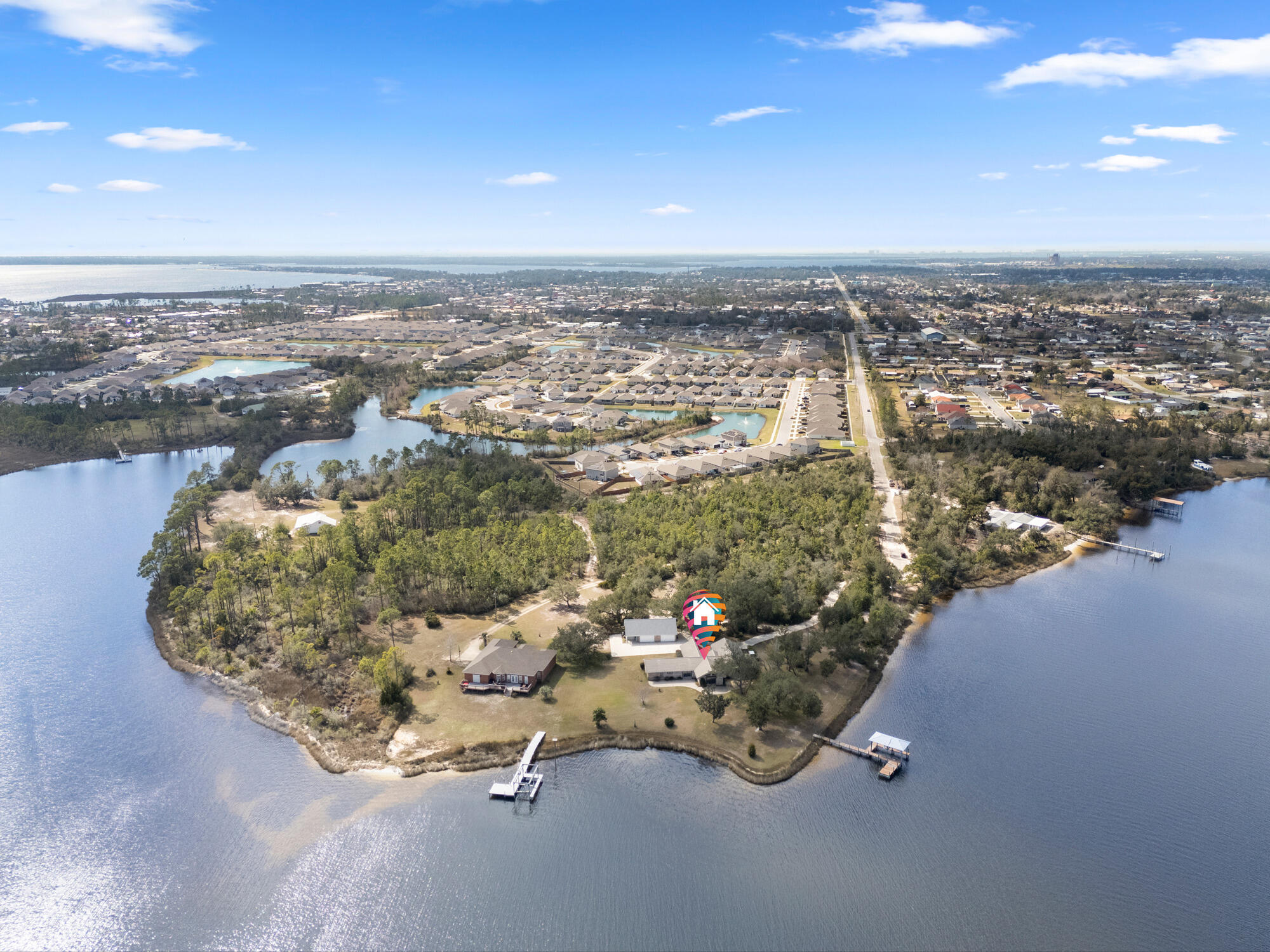 7300 Boat Race Road. This stunning 10+ acre waterfront property in Bay County, includes over 900 feet of frontage on Callaway Bayou. With easy and direct access to East Bay, St. Andrews Bay, and the Gulf of America, this prized location sits on a point, offering unmatched panoramic views of the water and surrounding wildlife habitat. The home combines luxury and functionality. The gourmet kitchen features a custom breakfast bar, two dishwashers, a built-in ice maker, separate below counter freezer drawers, a Sub-Zero refrigerator, a five-burner propane gas cooktop, a vented range hood, a warming drawer, and a convection microwave oven. Vaulted ceilings with exposed wood beams enhance the open floor plan of the main living areas. Crown moulding throughout the home highlights the attention to details. With its own unobstructed view of the Bayou, the master suite includes a large walk-in closet, a separate cedar-lined closet, and also a private office. The spacious en-suite bath includes a walk-in shower, a separate jetted garden tub, double vanity, and a bidet. The guest wing of the house includes a large bedroom, full bathroom with a walk-in shower, a dining/living area with a wet bar. Separated from the main house by a pocket door, the guest wing has three external entry ways: a main door with foyer, access to a private patio from the bedroom, and access to the Bayou from the living room. Additional highlights include a whole house standby propane generator package, a central vacuum system, two geothermal HVAC systems, and two electric water heaters, and low-profile retractable hurricane shutters.  The exterior of the property is equally impressive, featuring a boat dock with a covered slip and boat lift. There is an attached garage as well as a 2-car detached garage with an exercise room, and a spacious loft area, ideal for storage or future expansion. This waterfront-front property is a unique and extraordinary Estate.