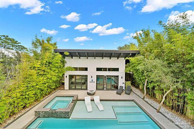 Located in the highly sought-after Seagrove Beach community with no HOA, 94 S Gulf Drive is an impeccably designed, custom-built modern masterpiece offering refined single-level living and total privacy. The chef's dream kitchen features a 12-foot island, Italian-made range & oven, butler's pantry, quartz countertops, and custom cabinetry. Light fills the open, airy floor plan with soaring ceilings and designer finishes. The primary suite delivers a spa experience with a 7-foot soaking tub and aromatherapy steam shower featuring eight shower heads and a rain feature. Every bath is fully tiled and wheelchair accessible. Outdoor living includes a screened-in porch, resort-style pool with 10-person hot tub