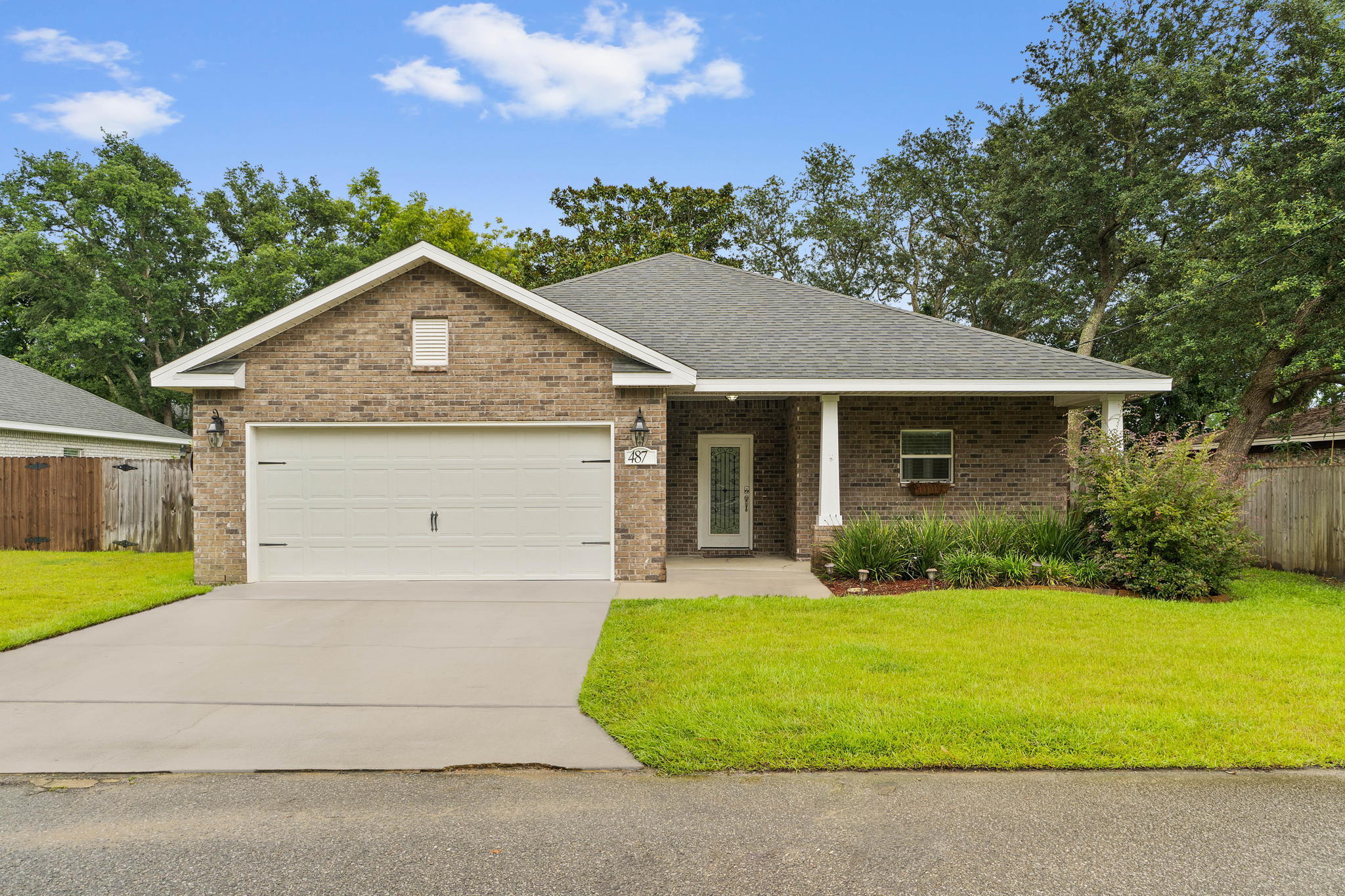 Welcome to this spacious newer construction home just minutes to Hurlburt Field and the Emerald Coast's gorgeous beaches! This practically brand new and well-maintained 3 bedroom, 2 bath is move-in ready. This all brick beauty has an inviting front porch leading to a gorgeous custom front door, and inside you'll find a split floor plan starting with a well appointed kitchen open to the massive great room accented with a double trey ceiling. The stunning kitchen has granite counters, custom cabinets, stainless appliances, and a kitchen island as well as a bar with plenty of room for seating under drop down pendant lighting. There are tons of windows throughout (all with blinds) and the oversized living room has plenty of room for all your furniture and comes complete with an accent wall with a tv mount, shelving, and a wall mounted electric fireplace. The owner's bedroom is a great size with a walk-in closet, and the owner's bathroom has tile flooring, double vanities with granite countertops, and a shower/tub combo. The other two bedrooms towards the front of the house down the first hallway are well appointed with ample closet space that share a full bathroom, and the extremely deep laundry room is located across from them. The two car garage has a garage door opener and outside you'll find a covered back porch, fenced in backyard, and sprinkler system. Welcome home!