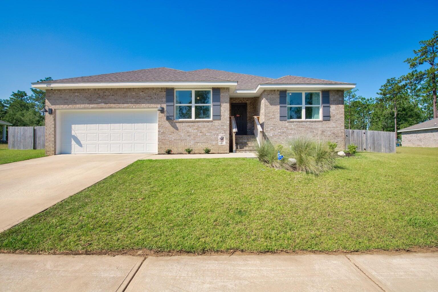 First month free if moved in by 10/15/2025!!  This spacious 5-bedroom, 3-bath home features an expansive open design, complemented by a covered patio and a 2-car garage. Throughout the home, enjoy wood-look flooring with plush carpeting in the bedrooms. The kitchen offers a large island bar, perfect for additional seating, along with a smooth top range, built-in microwave, stainless steel appliances, and a generous corner pantry. Adjacent to the kitchen, a cozy breakfast nook and separate dining area offer ample space for gatherings. The primary bedroom is accompanied by a stunning ensuite bathroom featuring a double vanity, large shower, and a spacious walk-in closet. No smoking allowing. Pets allowed pending owner approval and pet fee.